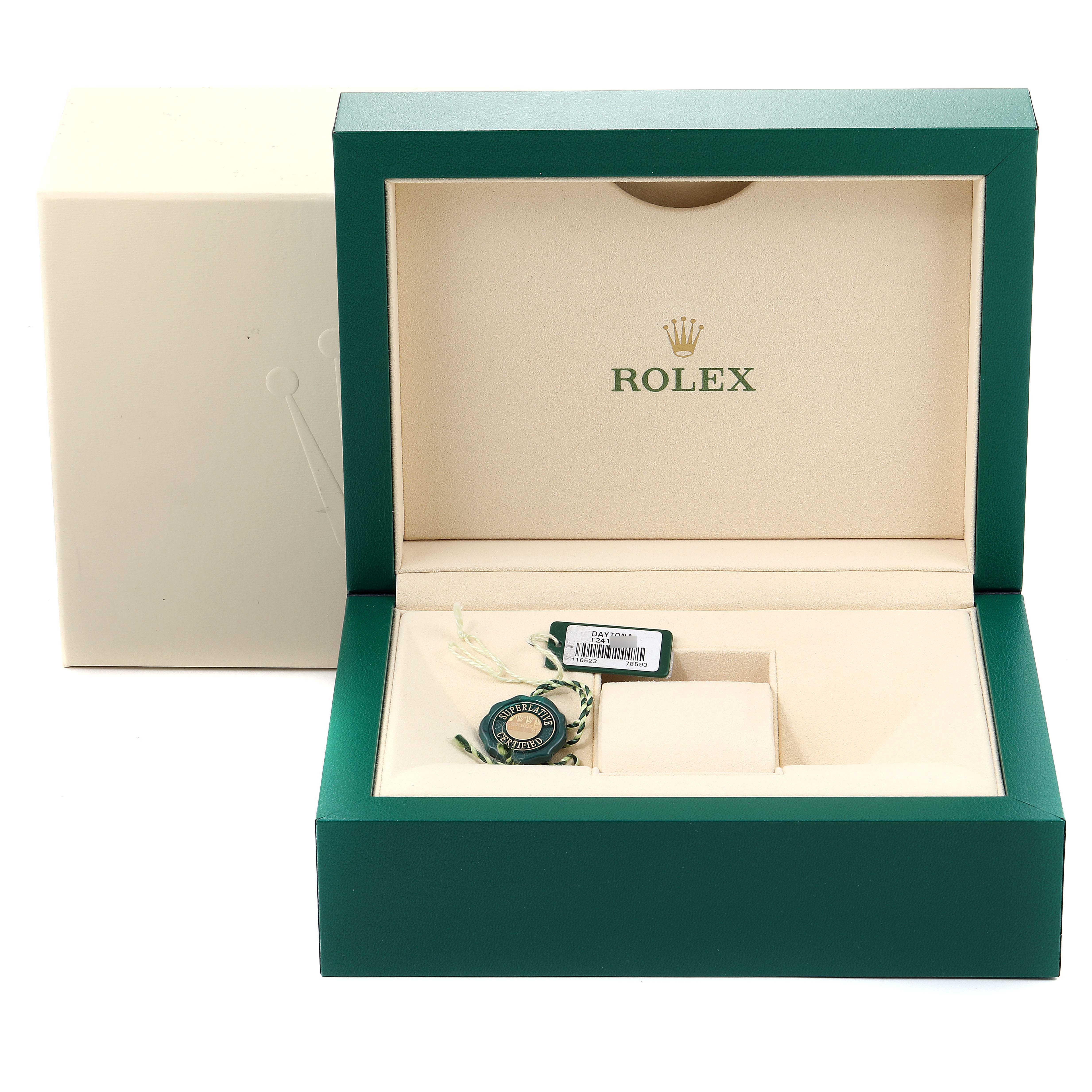 This image shows an open Rolex watch box for the Daytona model, displaying an accessory and a tag inside.