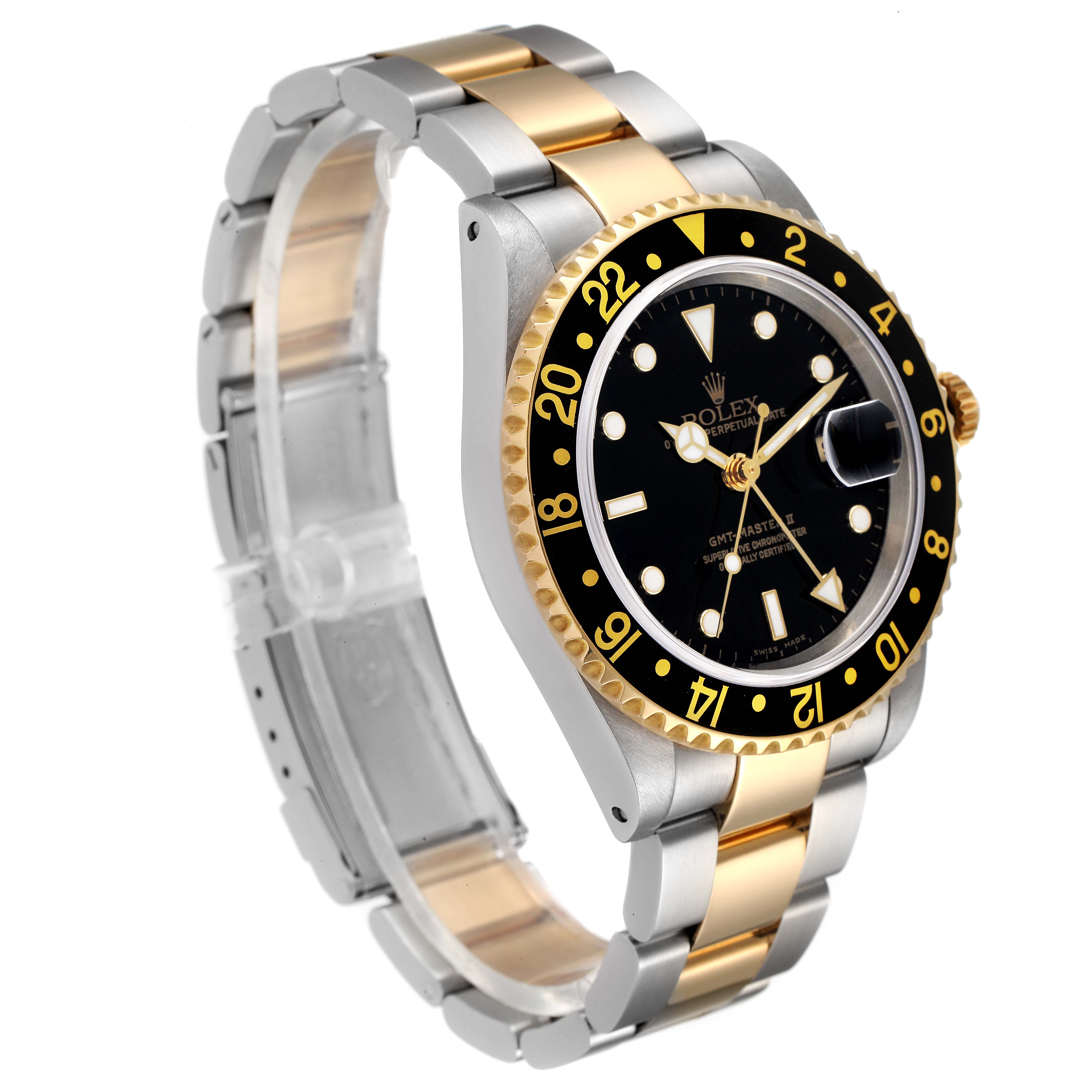 The Rolex GMT-Master 16713 Men's Steel and Gold (two tone) Black Dial 16713 Men's Steel and Gold (two tone) Black Dial watch is shown at an oblique angle, displaying its black dial, two-tone bracelet, and gold bezel with a date magnifier.