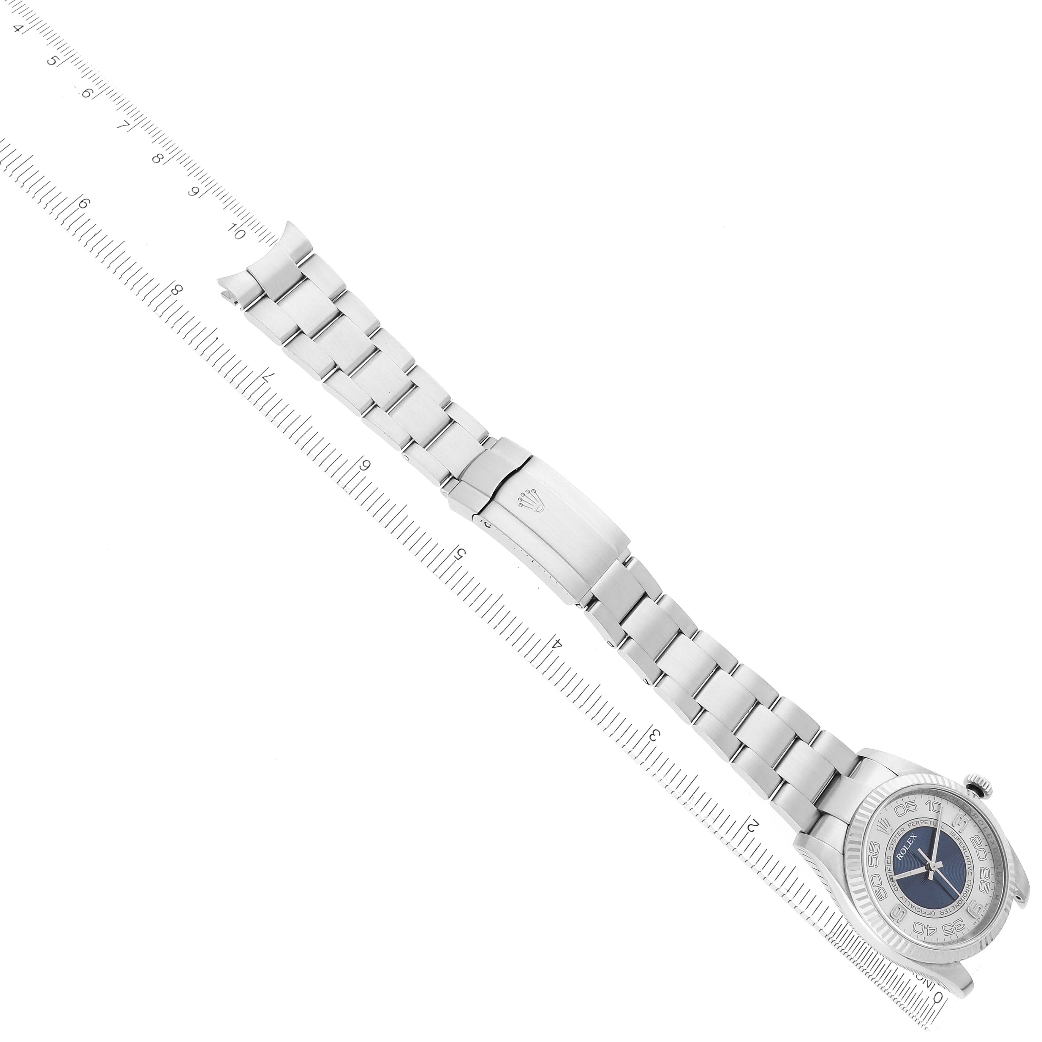 The image shows a Rolex Oyster Perpetual 116034 Men
s Stainless Steel Blue Dial watch laid flat, displaying the watch face and full bracelet with a ruler for scale.