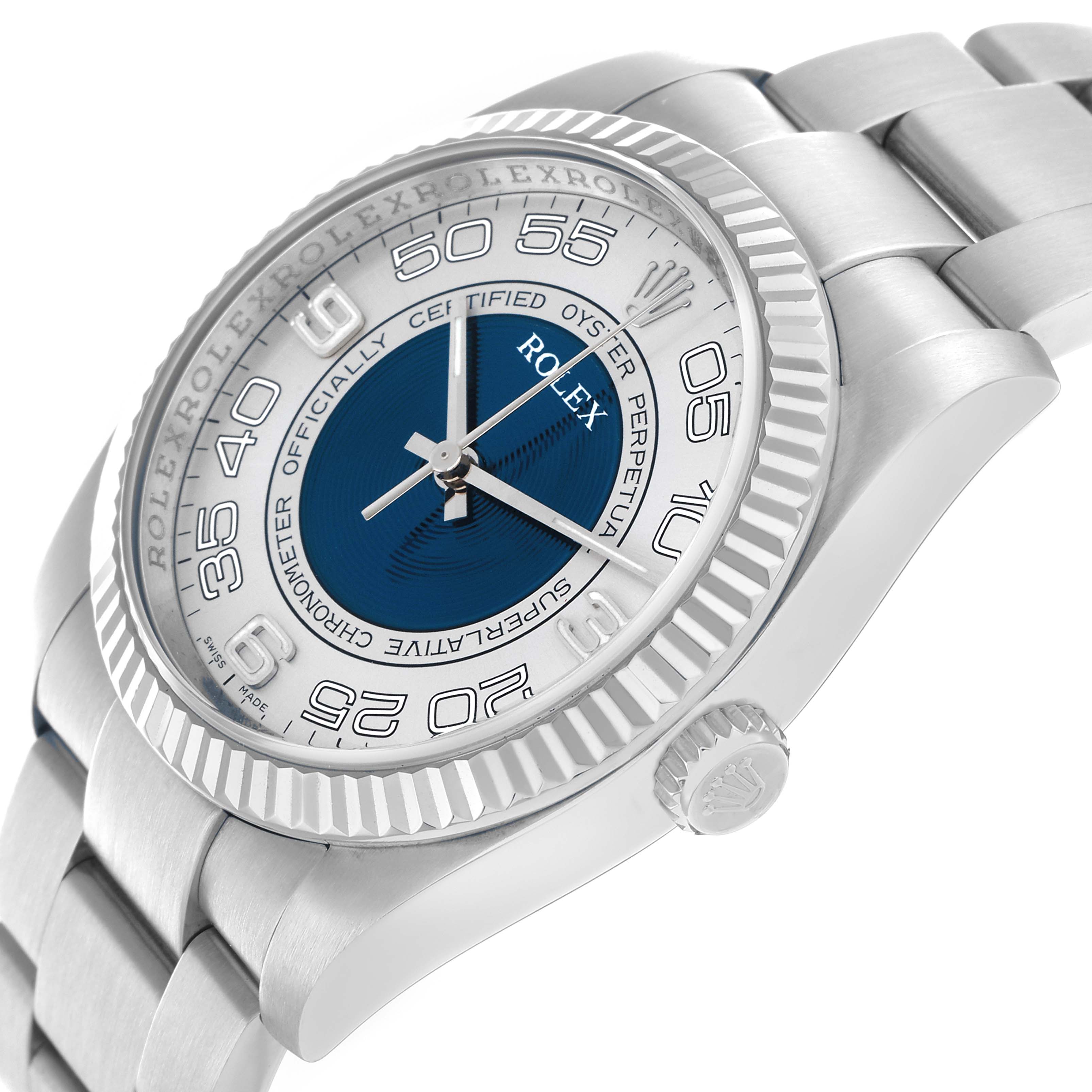 The Rolex Oyster Perpetual 116034 Men
s Stainless Steel Blue Dial watch is shown from an angled view, highlighting the bezel, crown, dial, and part of the bracelet.