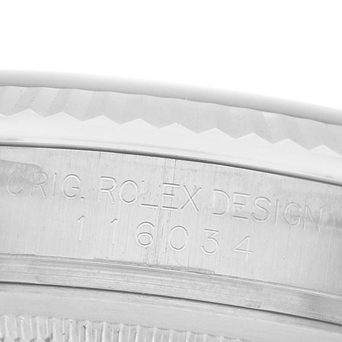 The image shows a close-up of the case side engraving on a Rolex Oyster Perpetual 116034 Men
s Stainless Steel Blue Dial watch.