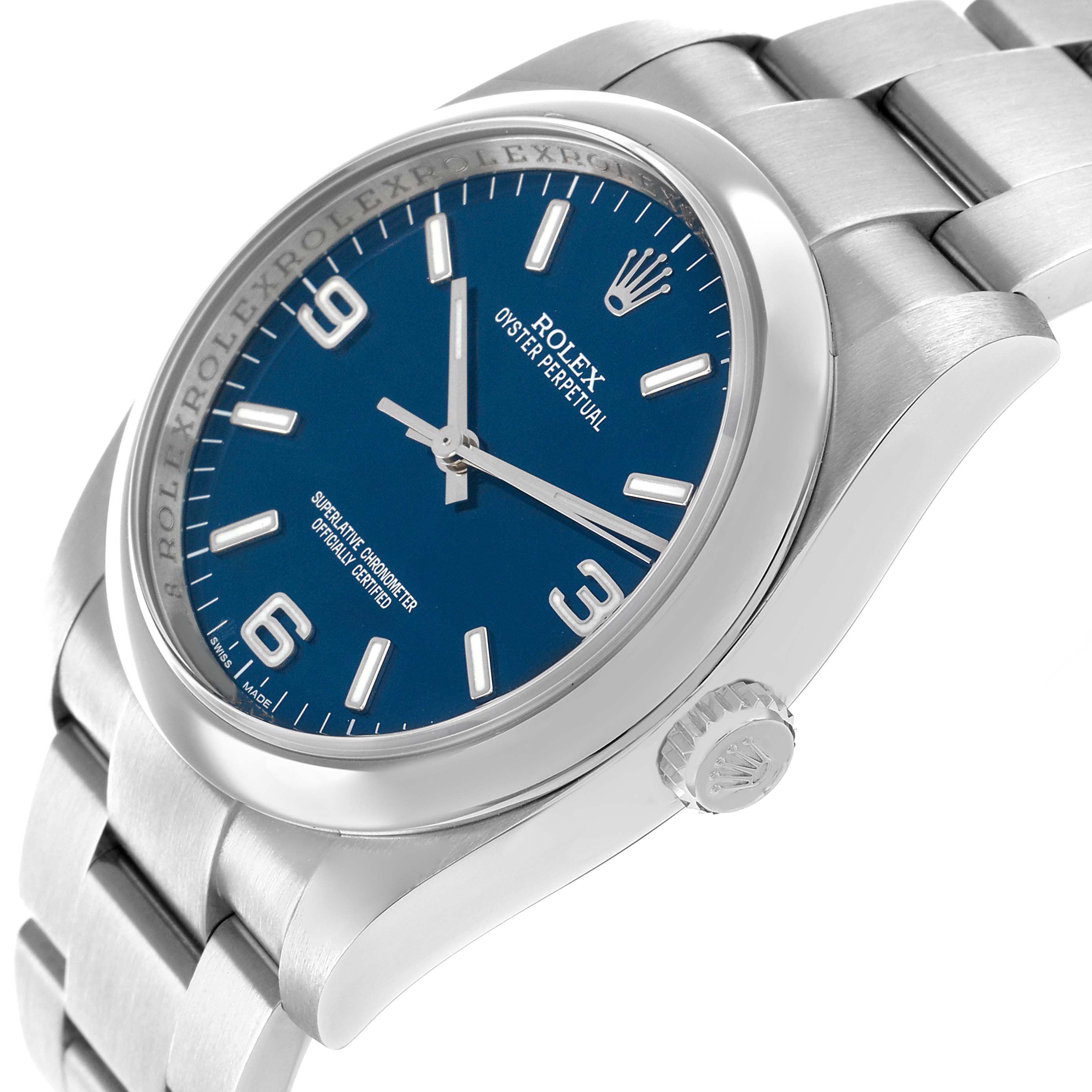 The Rolex Oyster Perpetual 116000 Men's Stainless Steel Blue Dial watch is shown from an angled side view, highlighting the blue dial, bezel, crown, and bracelet.