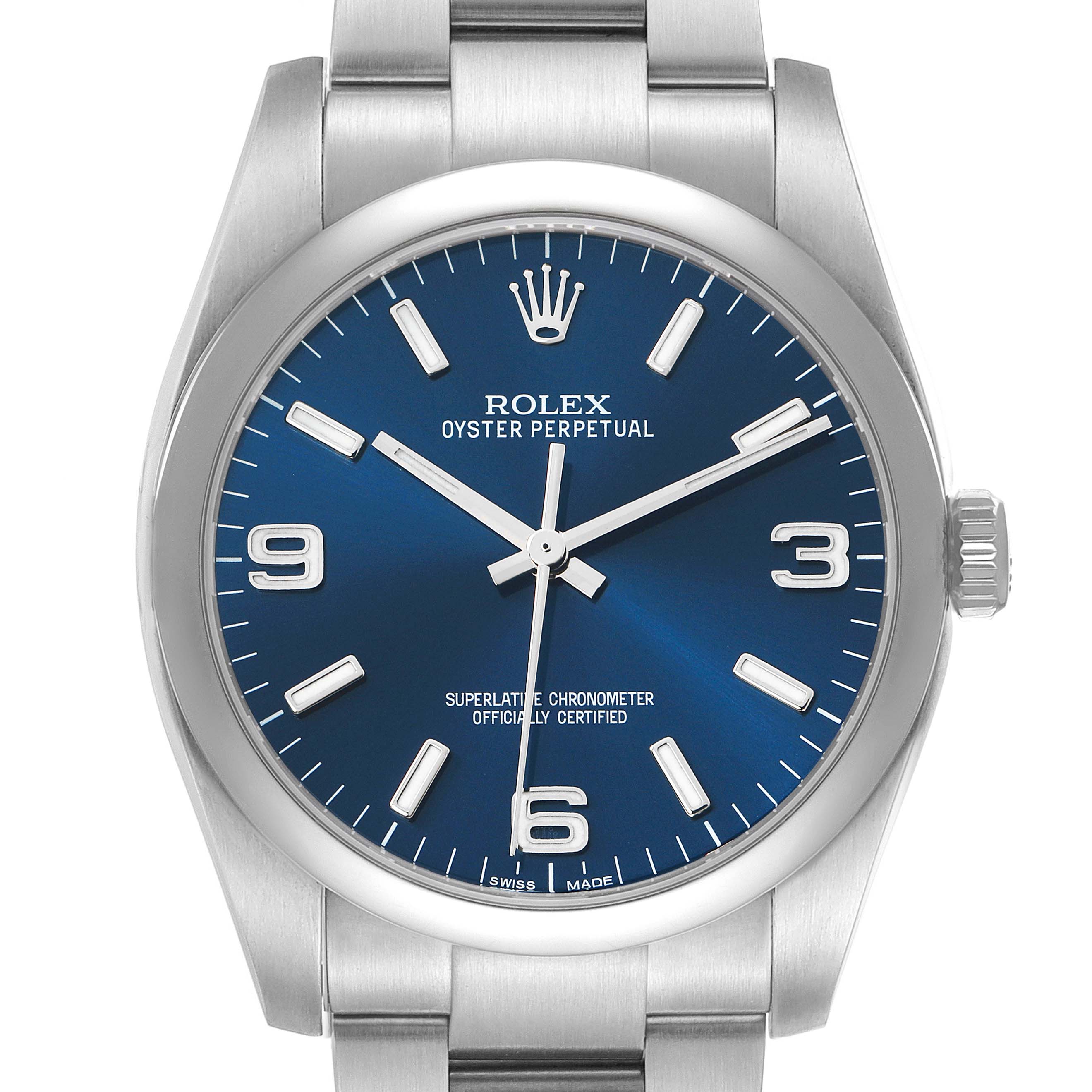 The image shows a frontal view of a Rolex Oyster Perpetual 116000 Men's Stainless Steel Blue Dial watch, highlighting its blue dial and silver hour markers.