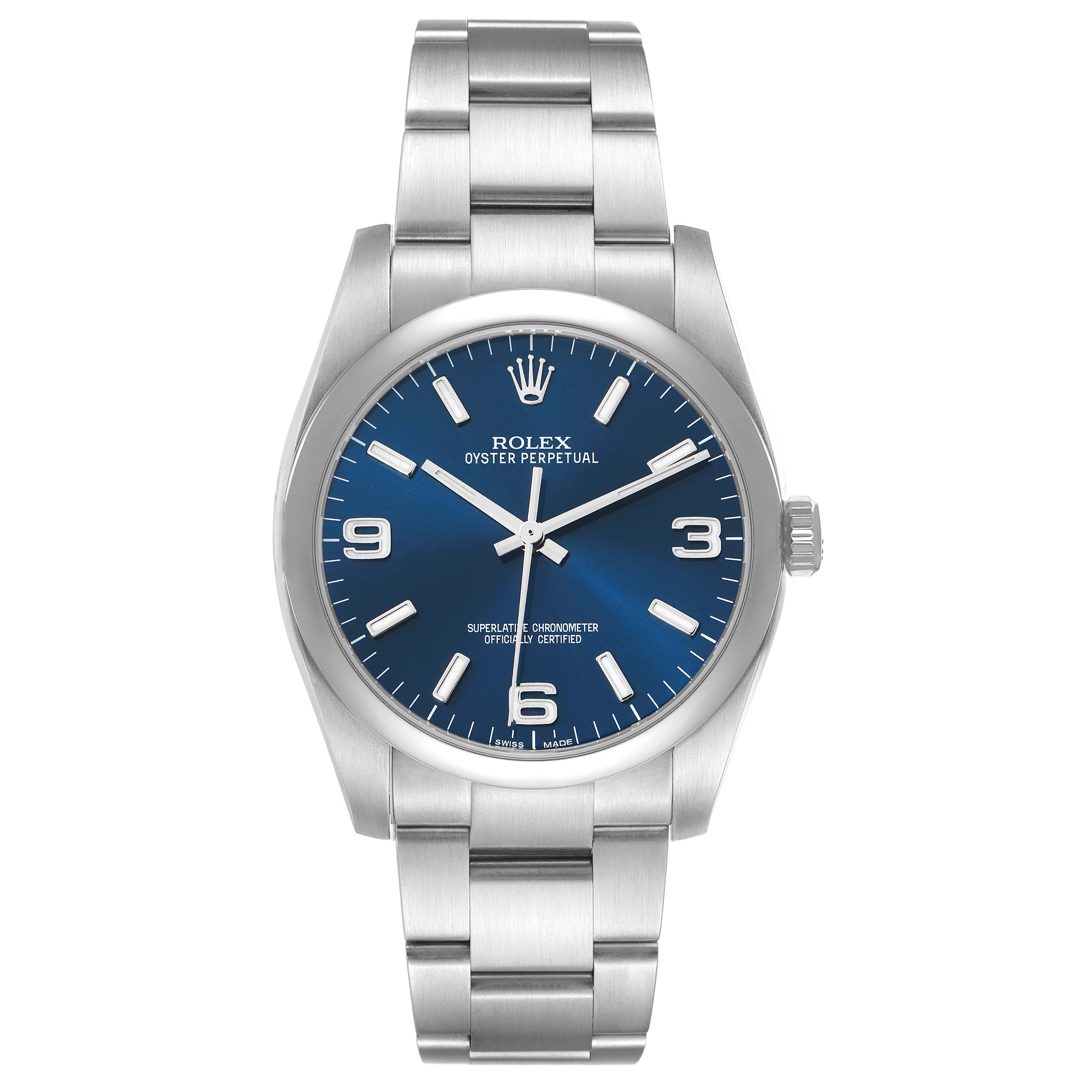 The Rolex Oyster Perpetual 116000 Men's Stainless Steel Blue Dial watch is shown from a front angle, displaying the dial, case, and bracelet.