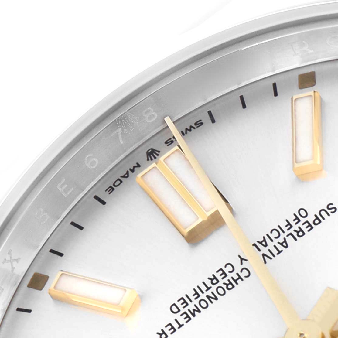 The image shows a close-up of the Rolex Oyster Perpetual 124300 Men
s Stainless Steel Silver Dial watch face, detailing the hour markers and part of the dial.