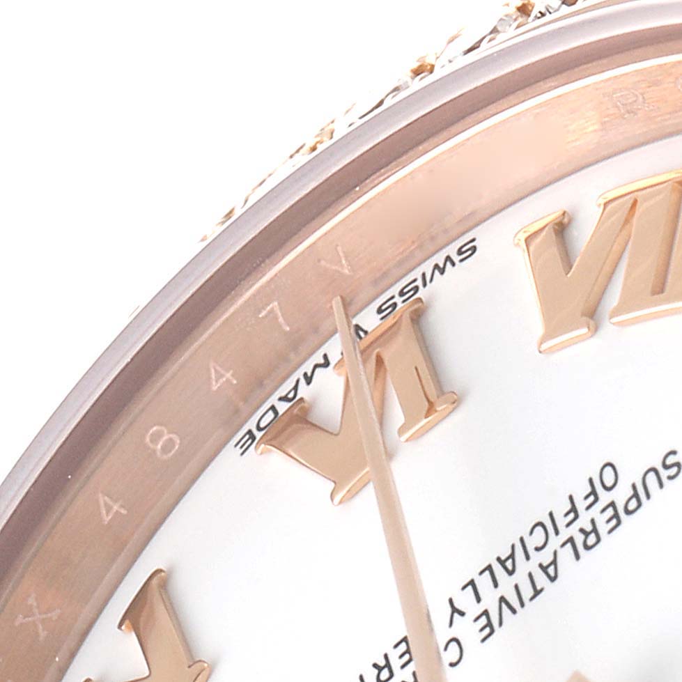 This close-up photo shows a portion of the bezel, dial, and Roman numeral markers of a Rolex President 278285 Women's Rose Gold White Dial 278285 Women's Rose Gold White Dial model watch.