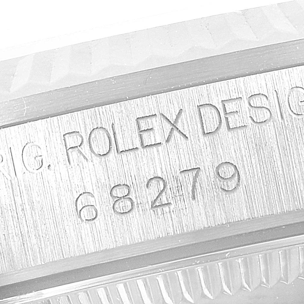 The image shows an angled close-up of the engraved serial number and model details for a Rolex President 68279 Women
s White Gold Silver Dial 68279 Women
s White Gold Silver Dial watch.