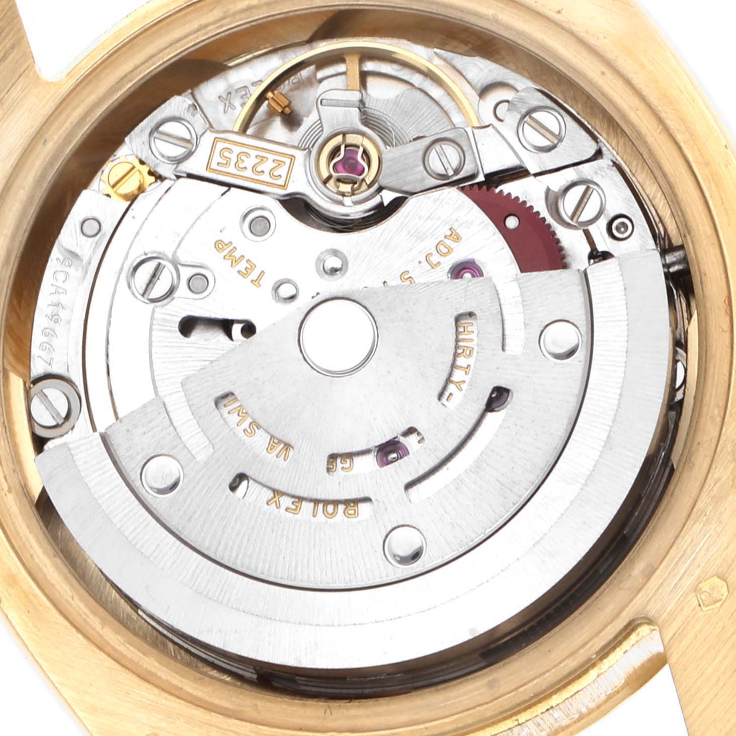 The image shows the movement of a Rolex President 179178 Women
s Yellow Gold Champagne Dial watch, highlighting gears and the rotor from a top-down angle.