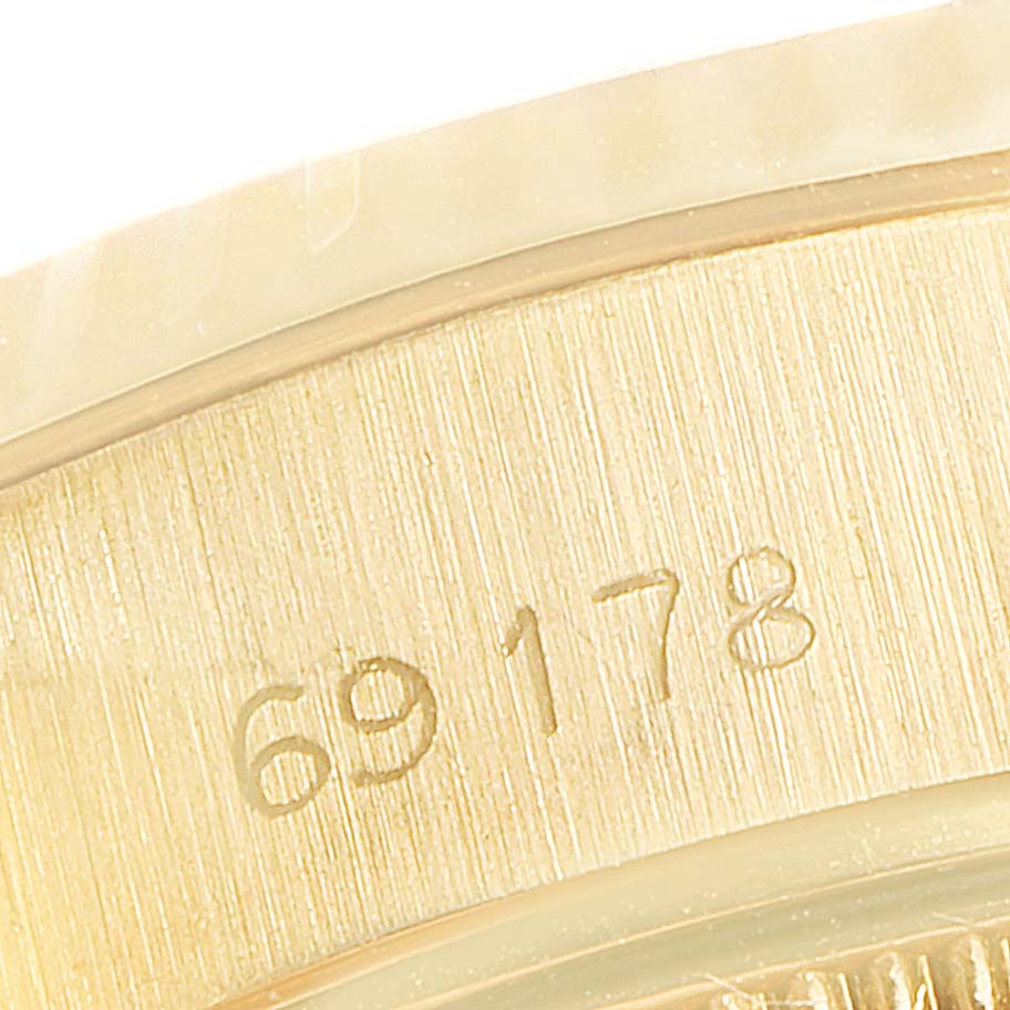 The image shows a close-up view of the side casing for the Rolex President 69178 Women's Yellow Gold Black Dial 69178 Women's Yellow Gold Black Dial model, featuring its engraved serial number.