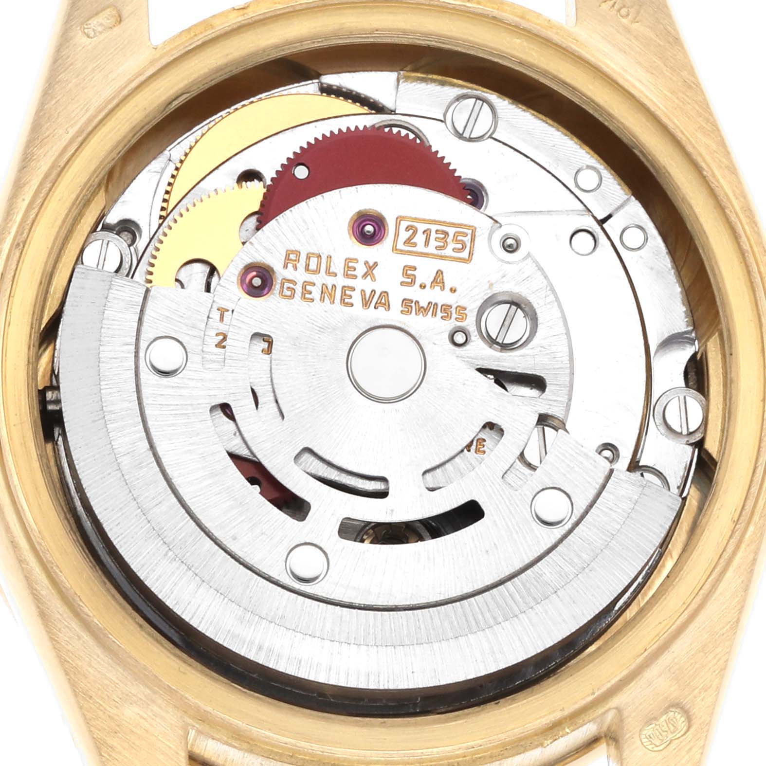 The image shows the movement mechanism of a Rolex President 69138 Women
s Yellow Gold Silver Dial model watch from a rear angle, highlighting the gears and rotor.