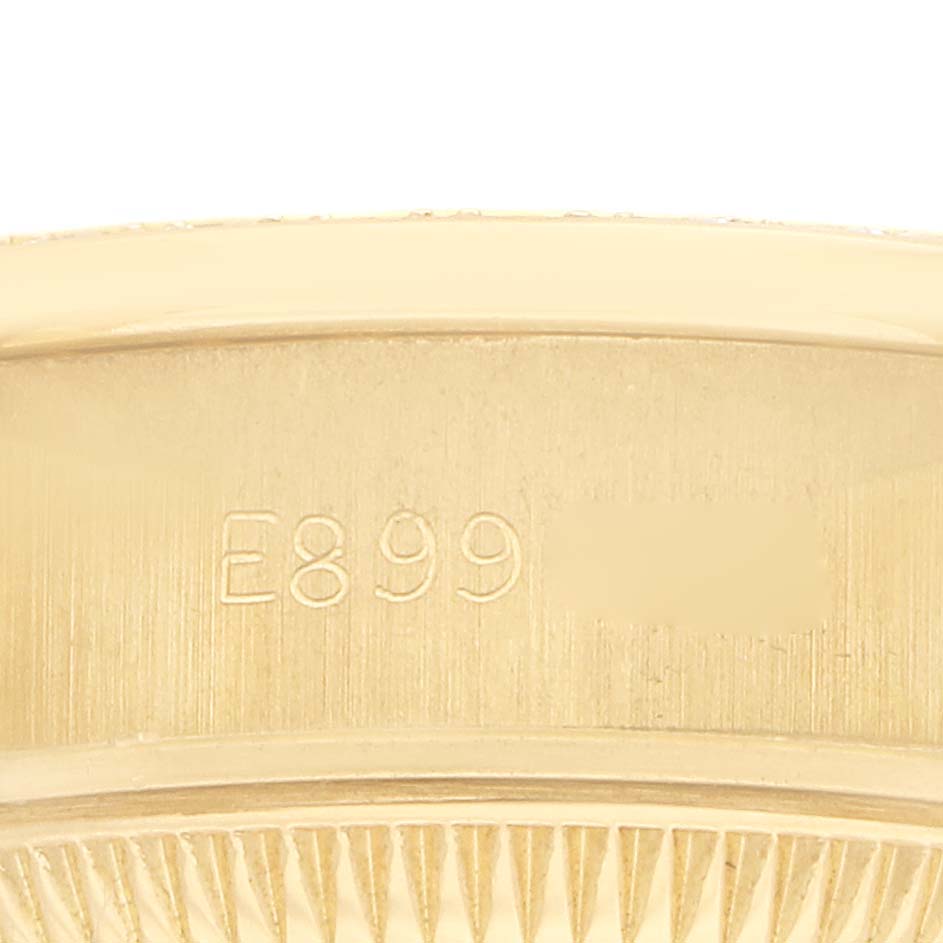 The image shows a close-up of the engraved inner bezel of a Rolex President 69138 Women
s Yellow Gold Silver Dial watch.