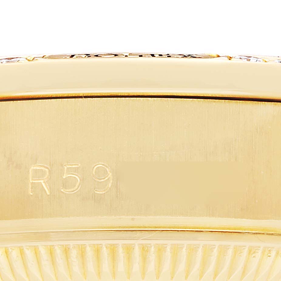 The image shows a close-up side view of the case edge with engravings on a Rolex President 69158 Women
s Yellow Gold Champagne Dial model watch.