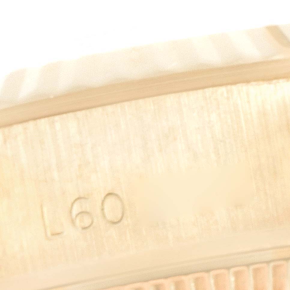 This image shows a close-up of the side of a Rolex President 69178 Women's Yellow Gold Black Dial 69178 Women's Yellow Gold Black Dial model watch, highlighting its engraved serial number.