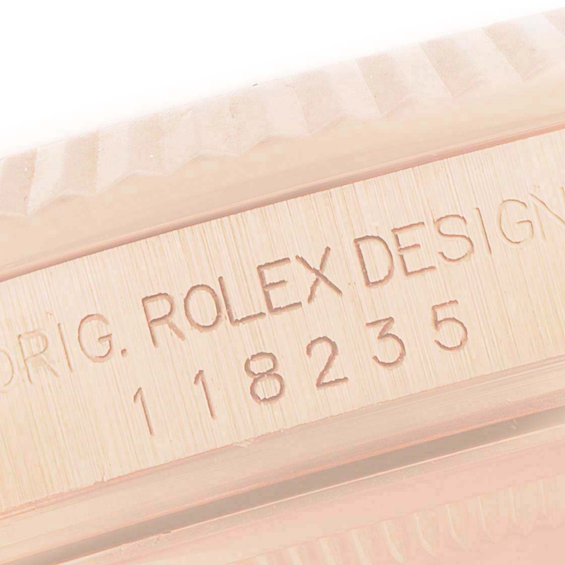 This is a close-up angle of the side of a Rolex President 118235 Men's Rose Gold Champagne Dial 118235 Men's Rose Gold Champagne Dial model watch, showing the engraved model number "118235" and brand name.