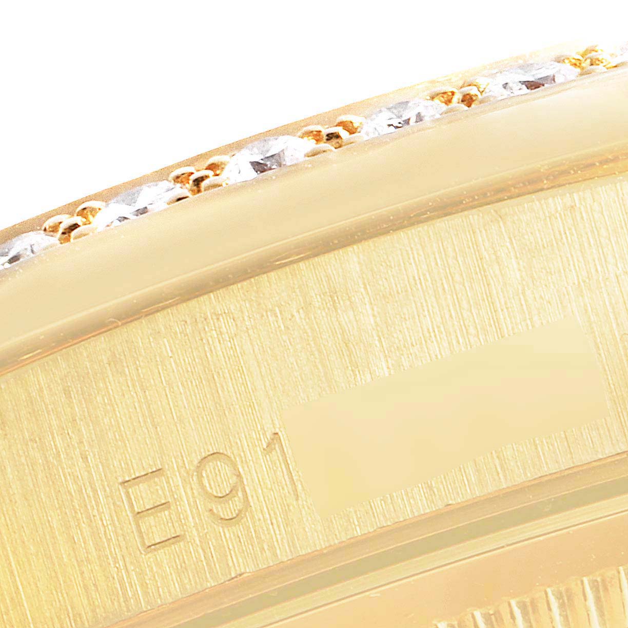 This image shows a close-up of the engraved serial number on the bezel of a Rolex President 18388 Men
s Yellow Gold Champagne Dial 18388 Men
s Yellow Gold Champagne Dial model watch.