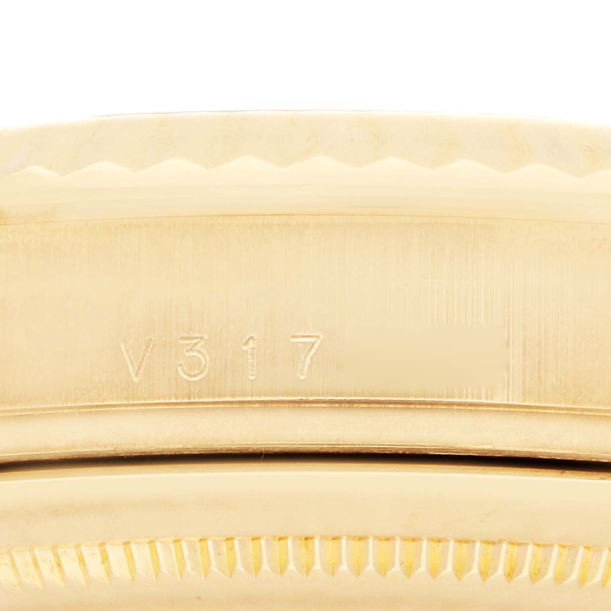 The image shows a close-up side view of the serial number engraved on the case of a Rolex President 218238 Men
s Yellow Gold Champagne Dial watch.