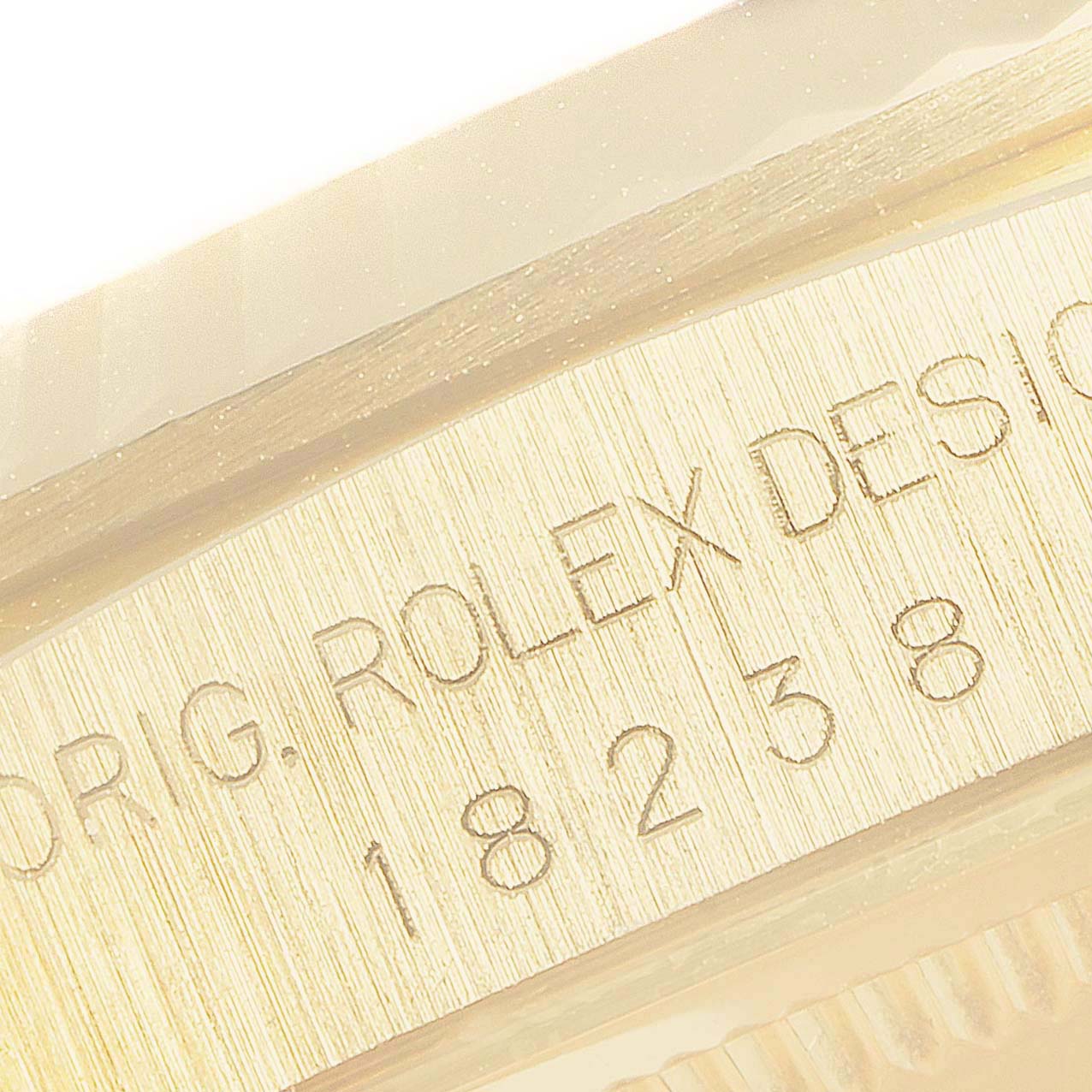 This close-up shot of a Rolex President 18238 Men
s Yellow Gold Champagne Dial 18238 Men
s Yellow Gold Champagne Dial model shows the watch’s reference number and design engravings on the case.