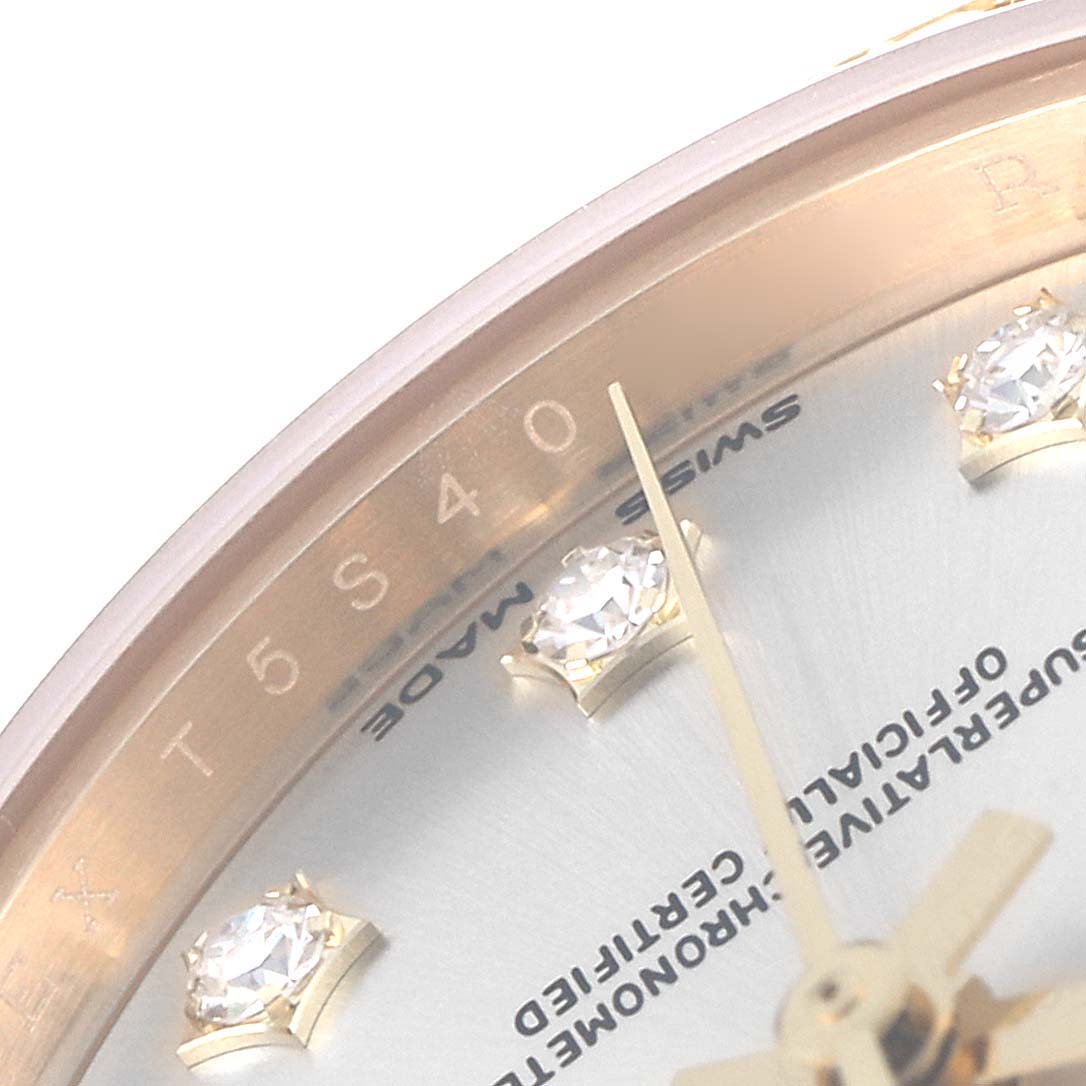 This close-up image of a Rolex President 279138 Women's Yellow Gold Silver Dial 279138 Women's Yellow Gold Silver Dial model watch shows a portion of the dial with diamond hour markers and the edge of the bezel.