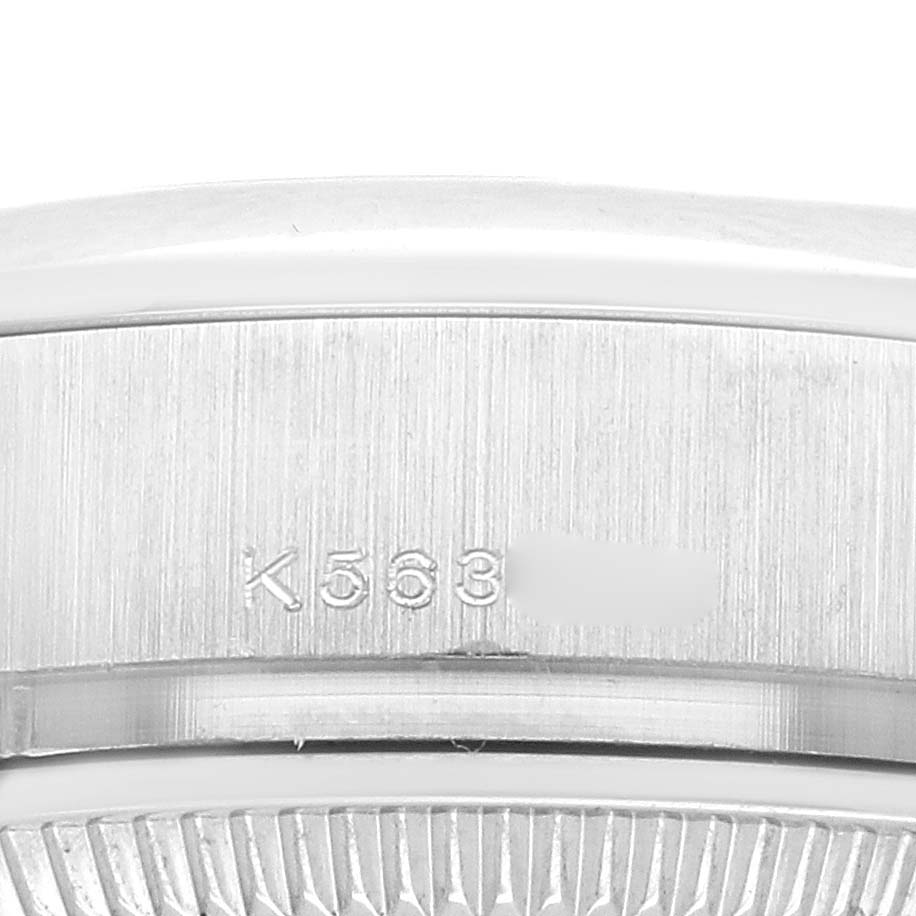 The image shows a close-up of a Rolex President 179166 Women
s Platinum Blue Dial watch, focusing on the serial number engraving on the side.