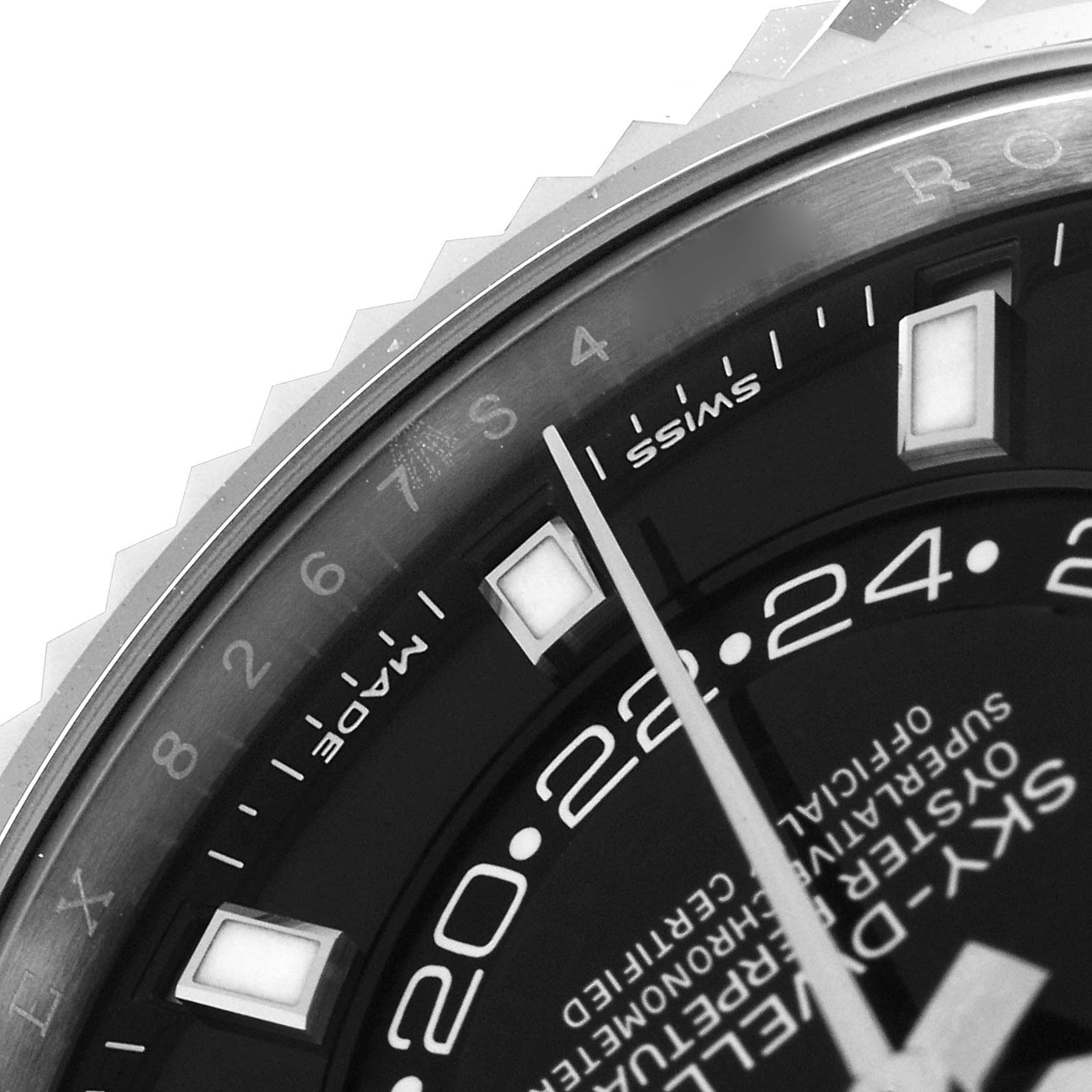 This image shows a close-up of the dial, bezel, and hour markers of a Rolex Sky-Dweller 326934 Men's Stainless Steel Black Dial 326934 Men's Stainless Steel Black Dial watch.