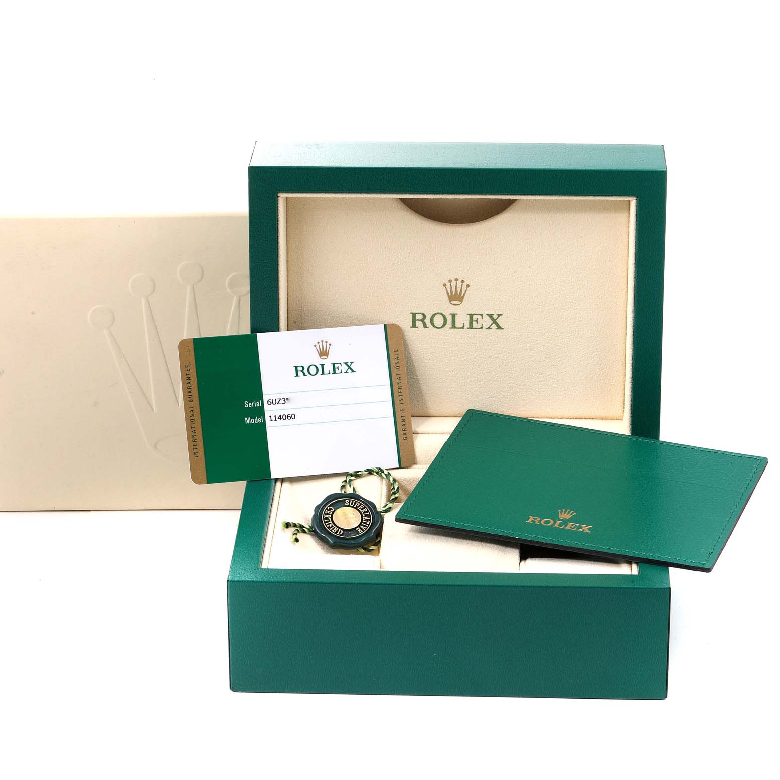 The image shows a Rolex Submariner 114060 Men
s Stainless Steel Black Dial 114060 Men
s Stainless Steel Black Dial
s box, card, tag, and booklet from a front angle.