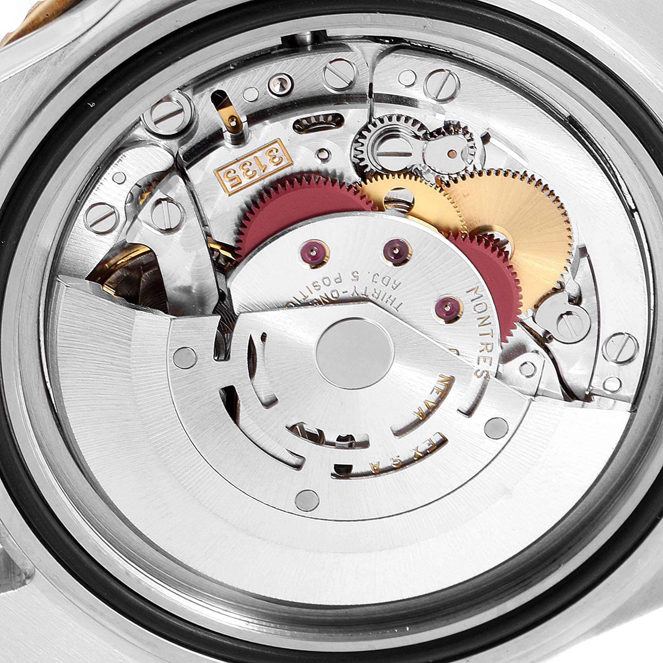 This image shows the intricate internal movement of a Rolex Submariner 16613 Men's Steel and Gold (two tone) Blue Dial 16613 Men's Steel and Gold (two tone) Blue Dial watch from a close-up, rear angle.