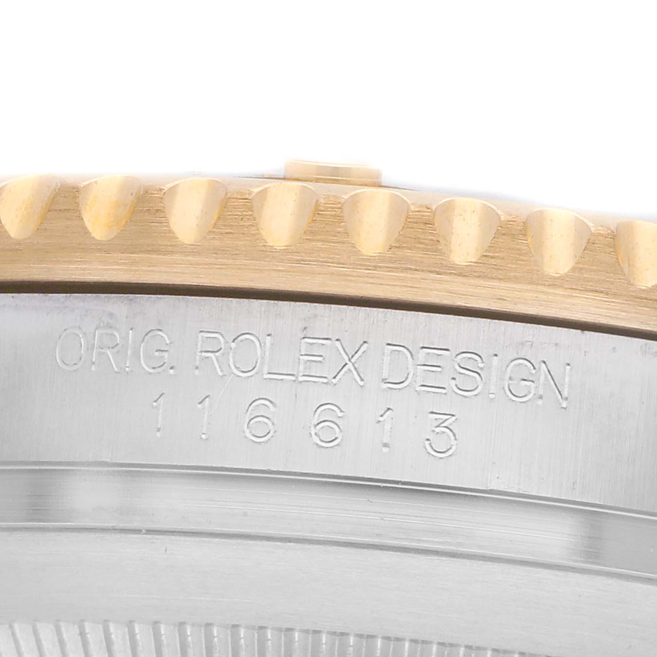 The image shows a close-up of the side of a Rolex Submariner 116613 Men
s Steel and Gold (two tone) Black Dial, highlighting the bezel edge and engraved design details.