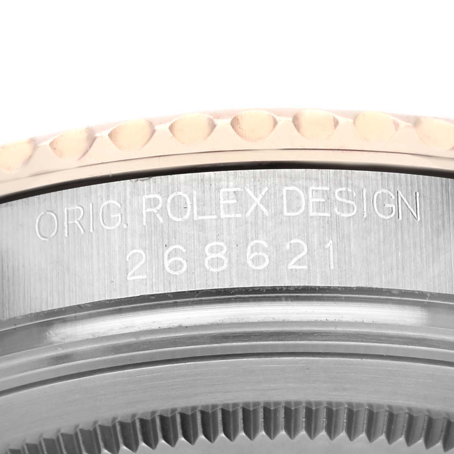 The image shows a close-up of the case side of a Rolex Yacht-Master 268621 Men's Steel and Gold (two tone) Brown Dial 268621 Men's Steel and Gold (two tone) Brown Dial watch with the engraving "ORIG. ROLEX DESIGN 268621."