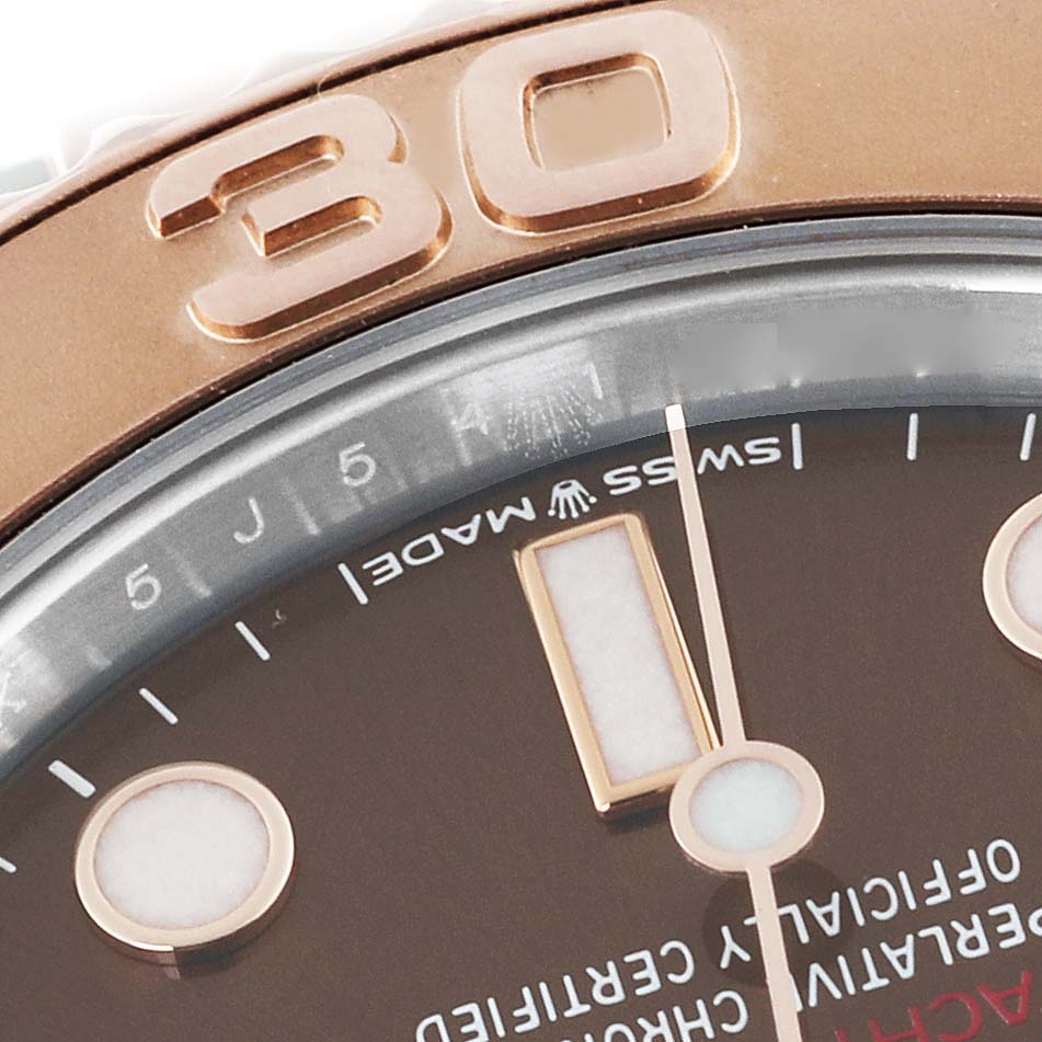 The image shows a close-up of the Rolex Yacht-Master 268621 Men's Steel and Gold (two tone) Brown Dial 268621 Men's Steel and Gold (two tone) Brown Dial’s bezel with the "30" mark, part of the dial, and hour markers.