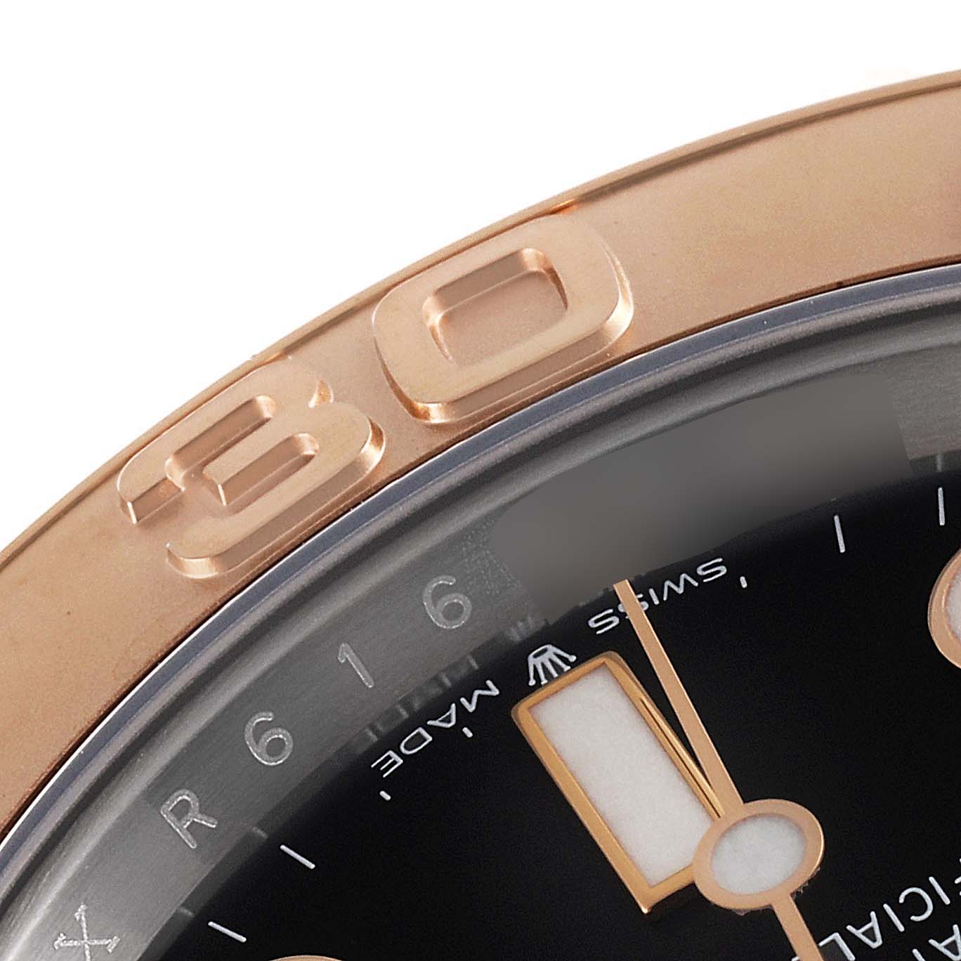 This is a close-up of the Rolex Yacht-Master 126621 Men
s Steel and Gold (two tone) Black Dial 126621 Men
s Steel and Gold (two tone) Black Dial watch, showing the bezel and part of the dial with the "30" minute marker.