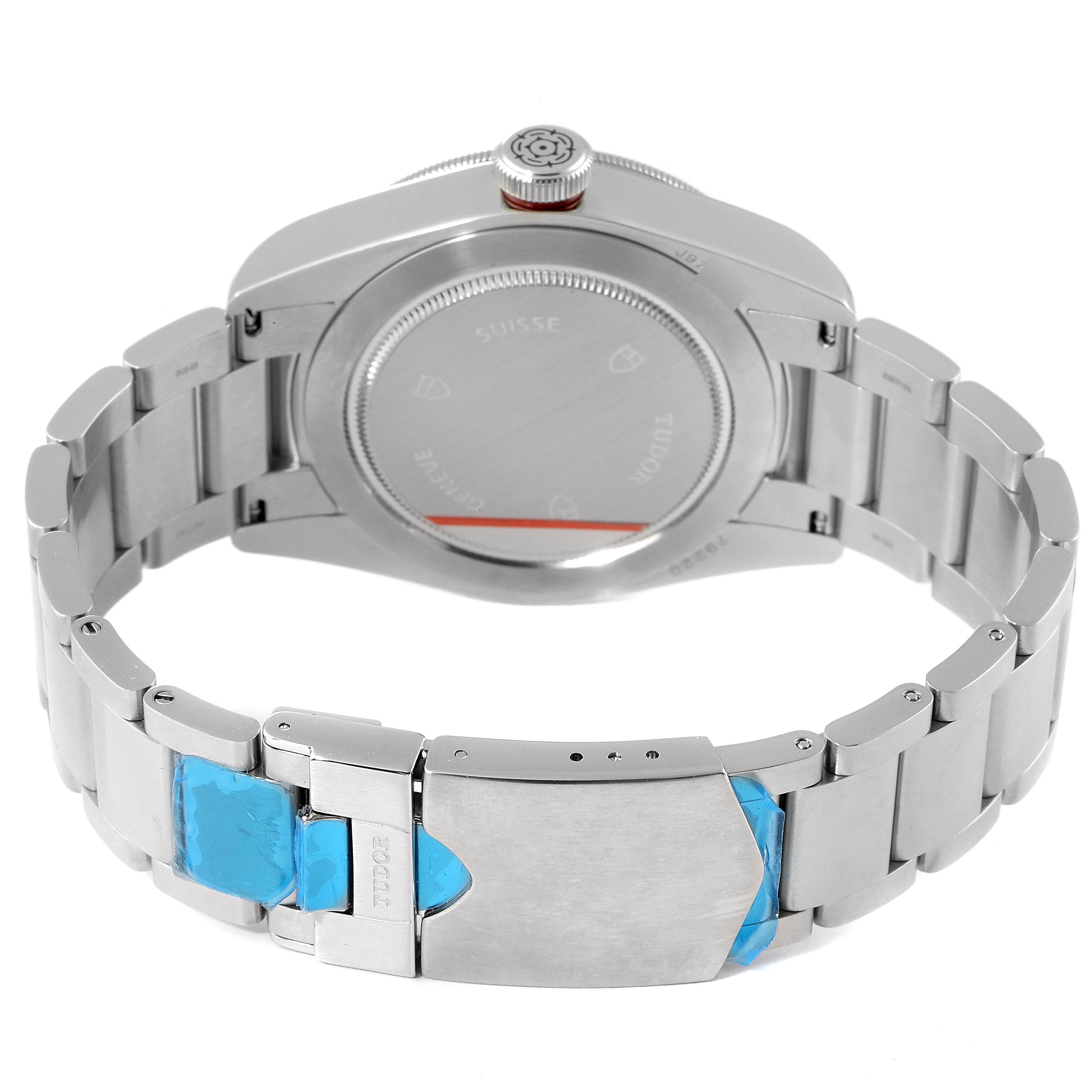 The image shows the backside and partially the bracelet of a Tudor Heritage Black Bay 79220R Men's Stainless Steel Black Dial 79220R Men's Stainless Steel Black Dial watch, prominently featuring the clasp and case back.