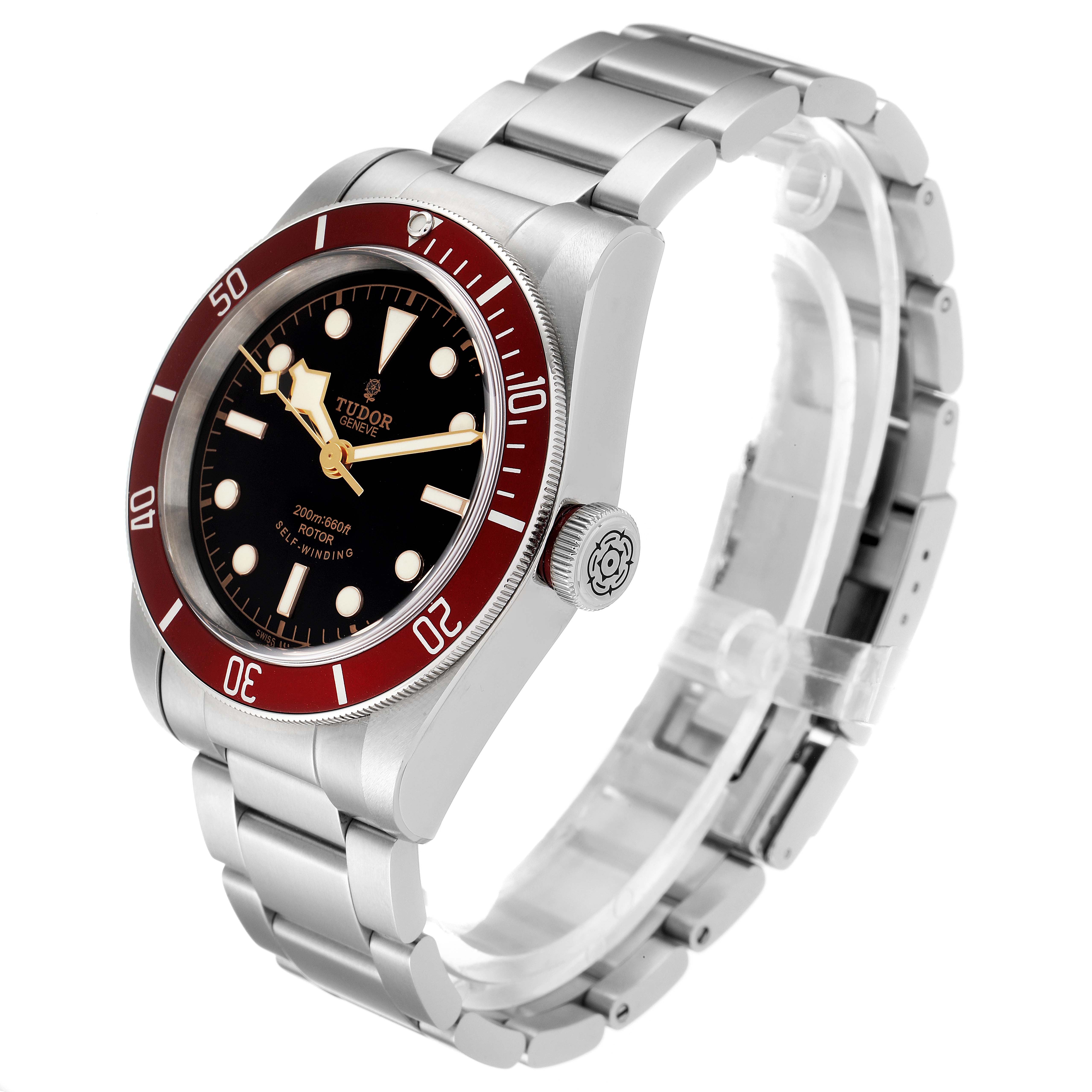 The Tudor Heritage Black Bay 79220R Men's Stainless Steel Black Dial 79220R Men's Stainless Steel Black Dial watch is shown at an angle highlighting the silver bracelet, black dial, red bezel, and crown with logo.