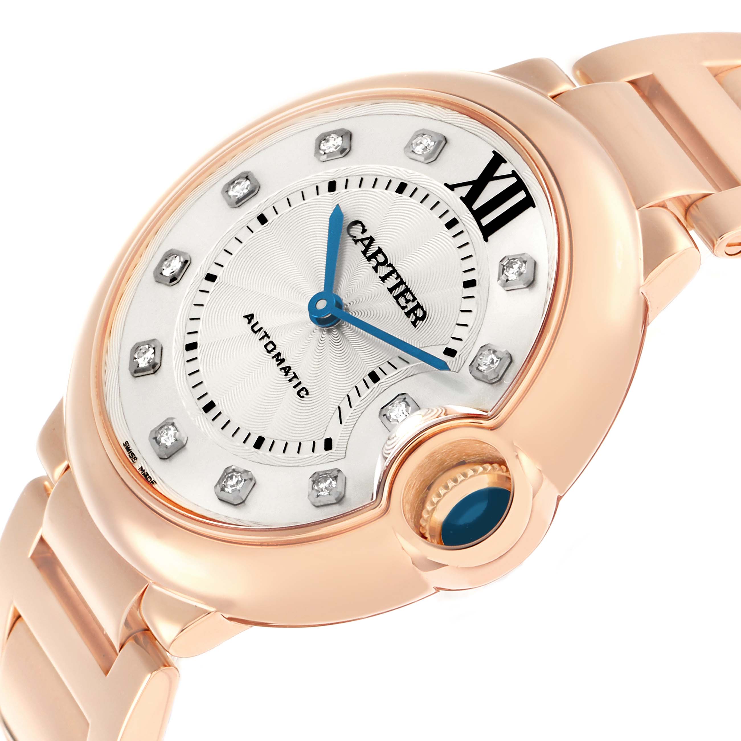 The Cartier Ballon Bleu WE902026 Women
s Rose Gold Silver Dial watch is shown at an angle emphasizing the dial, crown, and bracelet in rose gold, highlighting its blue hands and diamond markers.