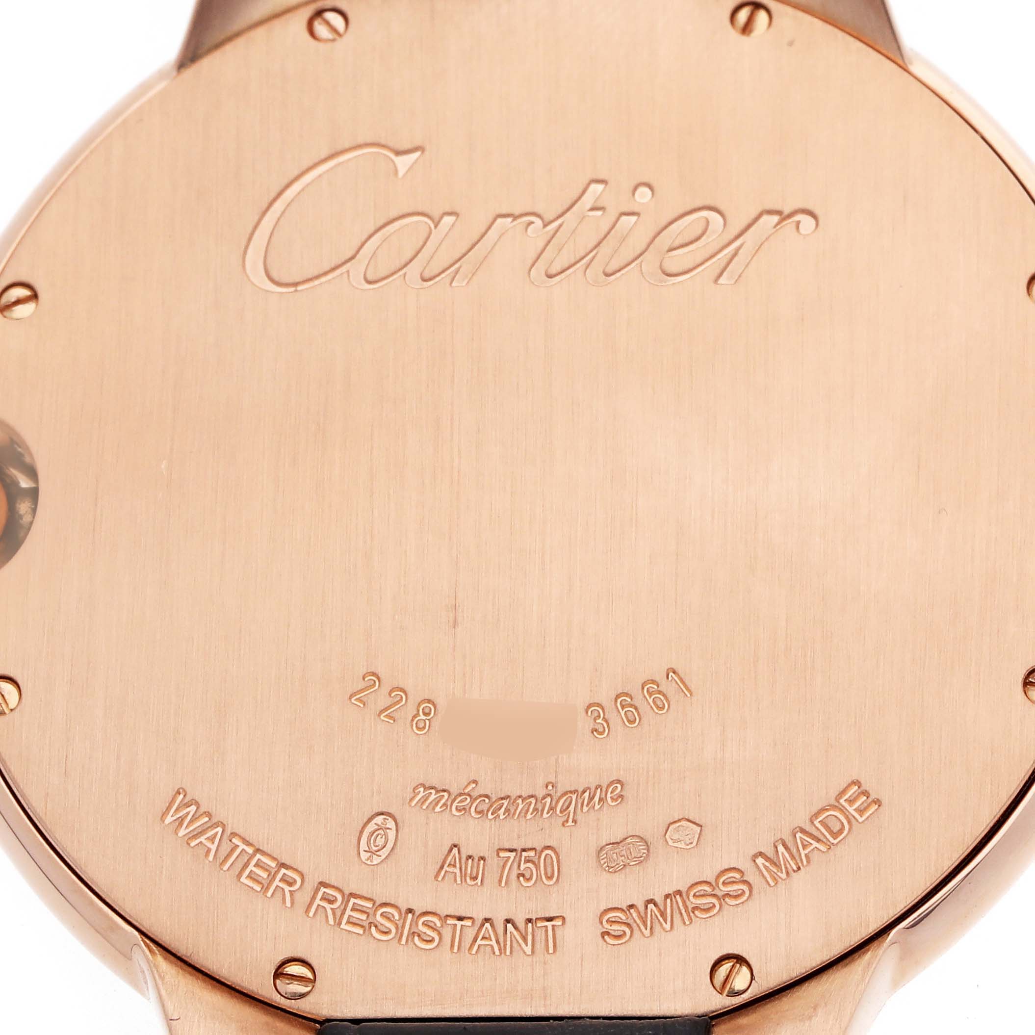 The image shows the back case of a Cartier Ballon Bleu W6920083 Men
s Rose Gold Silver Dial watch, highlighting engravings and markings.