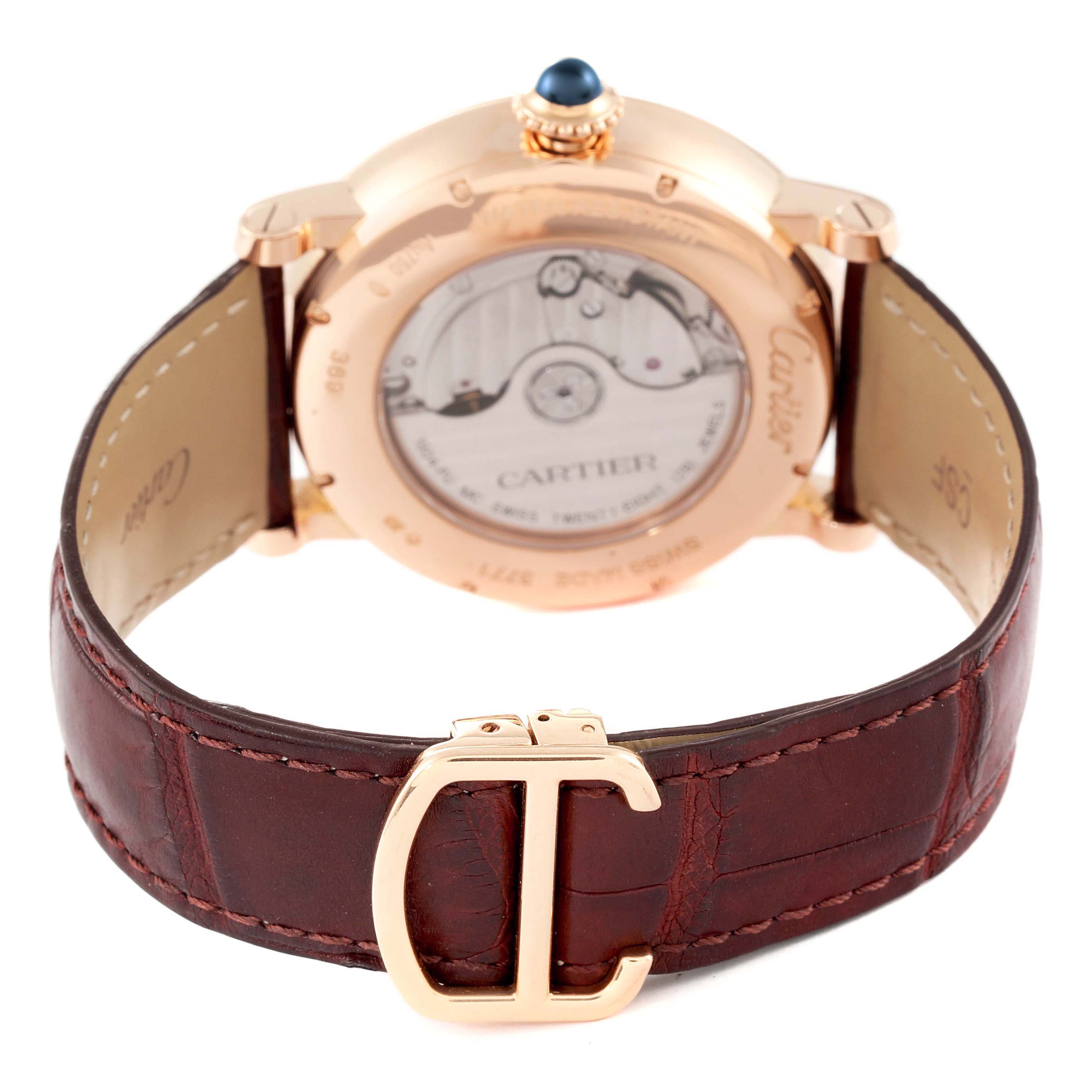 The image shows the back view of a Cartier Rotonde W1556240 Men
s Rose Gold Silver Dial W1556240 Men
s Rose Gold Silver Dial watch, highlighting its leather strap and transparent case back.