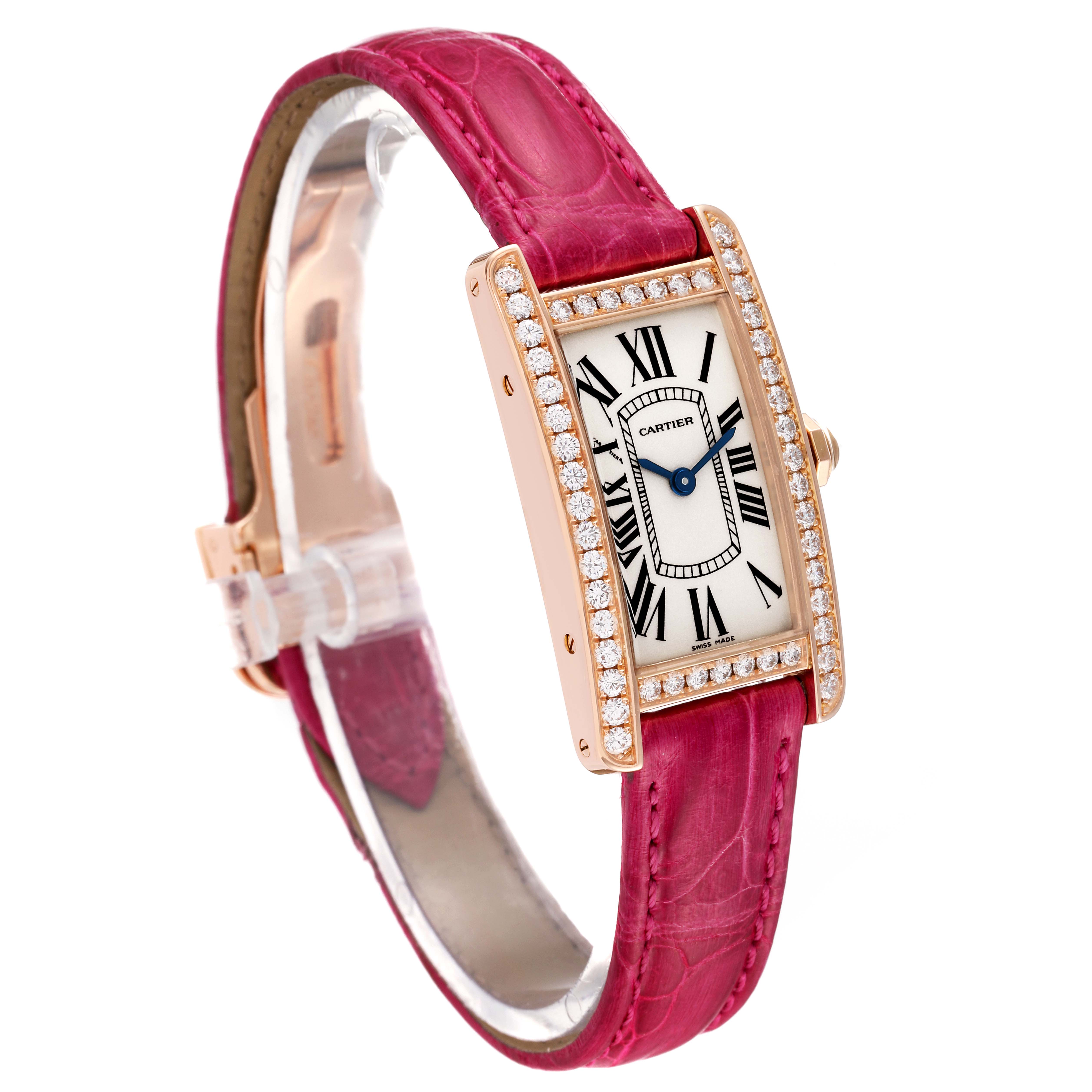 This Cartier Tank Americaine WJTA0002 Women
s Rose Gold Silver Dial WJTA0002 Women
s Rose Gold Silver Dial watch is displayed at a three-quarter angle, showing its diamond bezel, rectangular dial, and red strap.