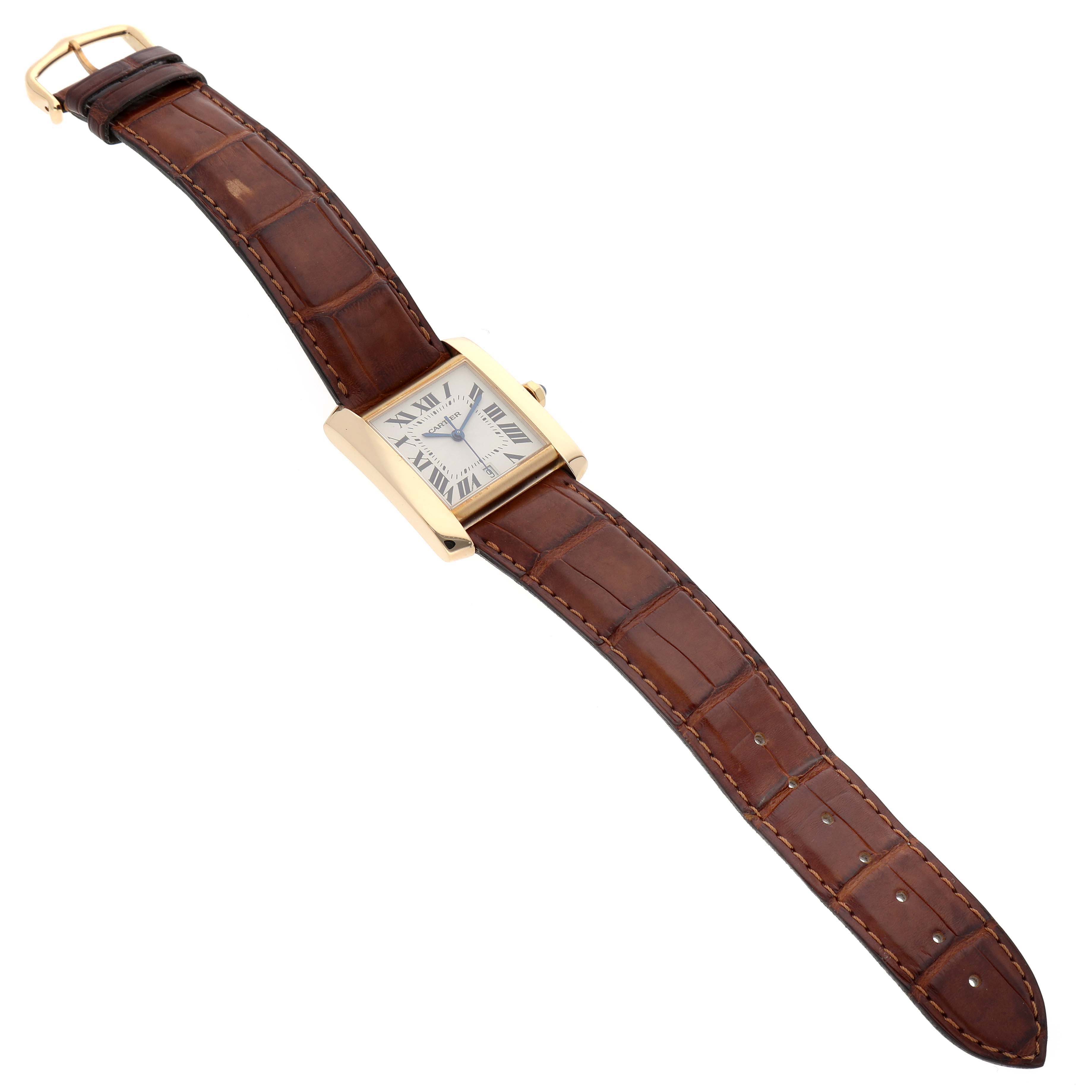 The Cartier Tank Française watch is shown from an angled side view, highlighting the leather strap and the square dial with Roman numerals.