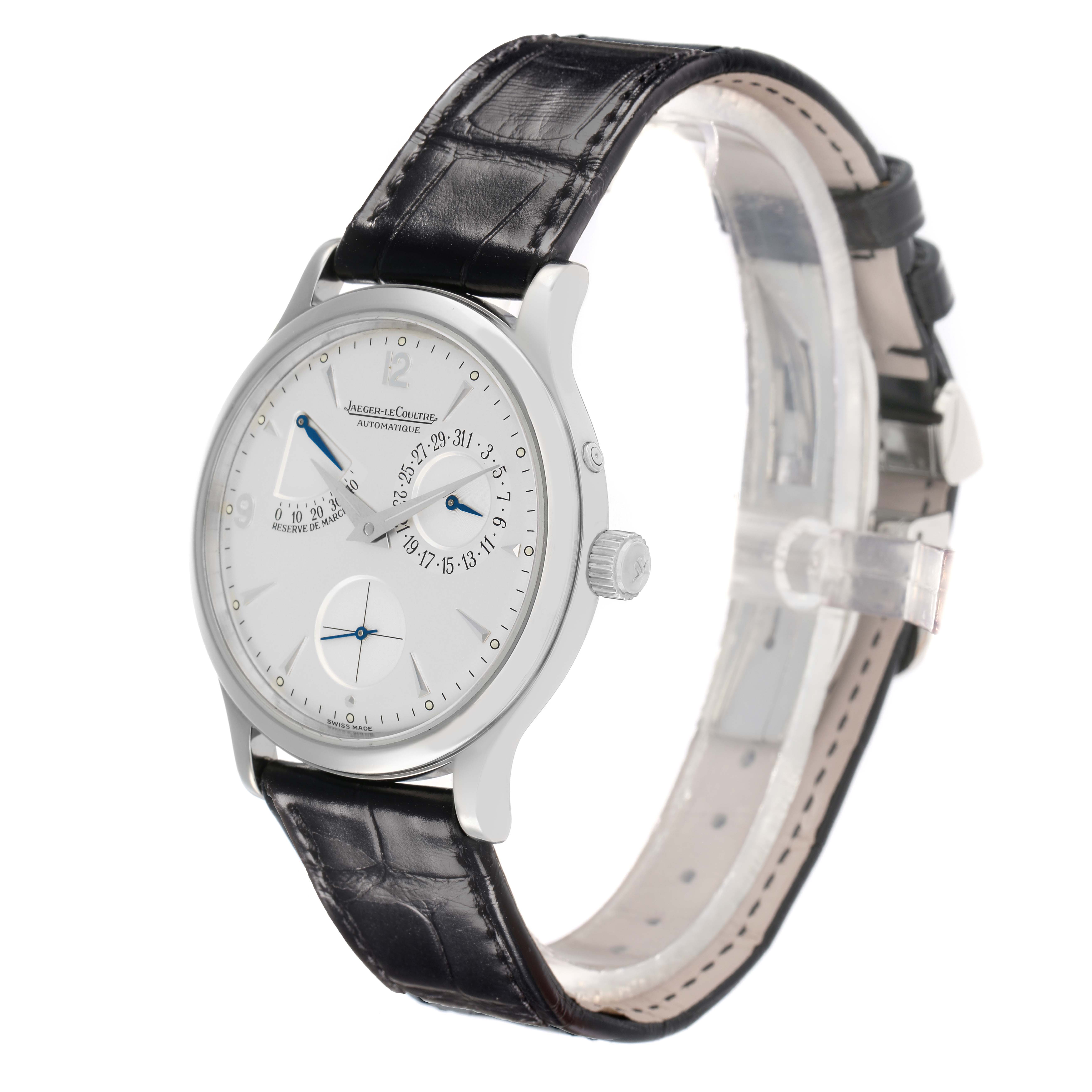 The Jaeger-LeCoultre Reverso watch is shown at an angled side view, highlighting the face, crown, and leather strap.