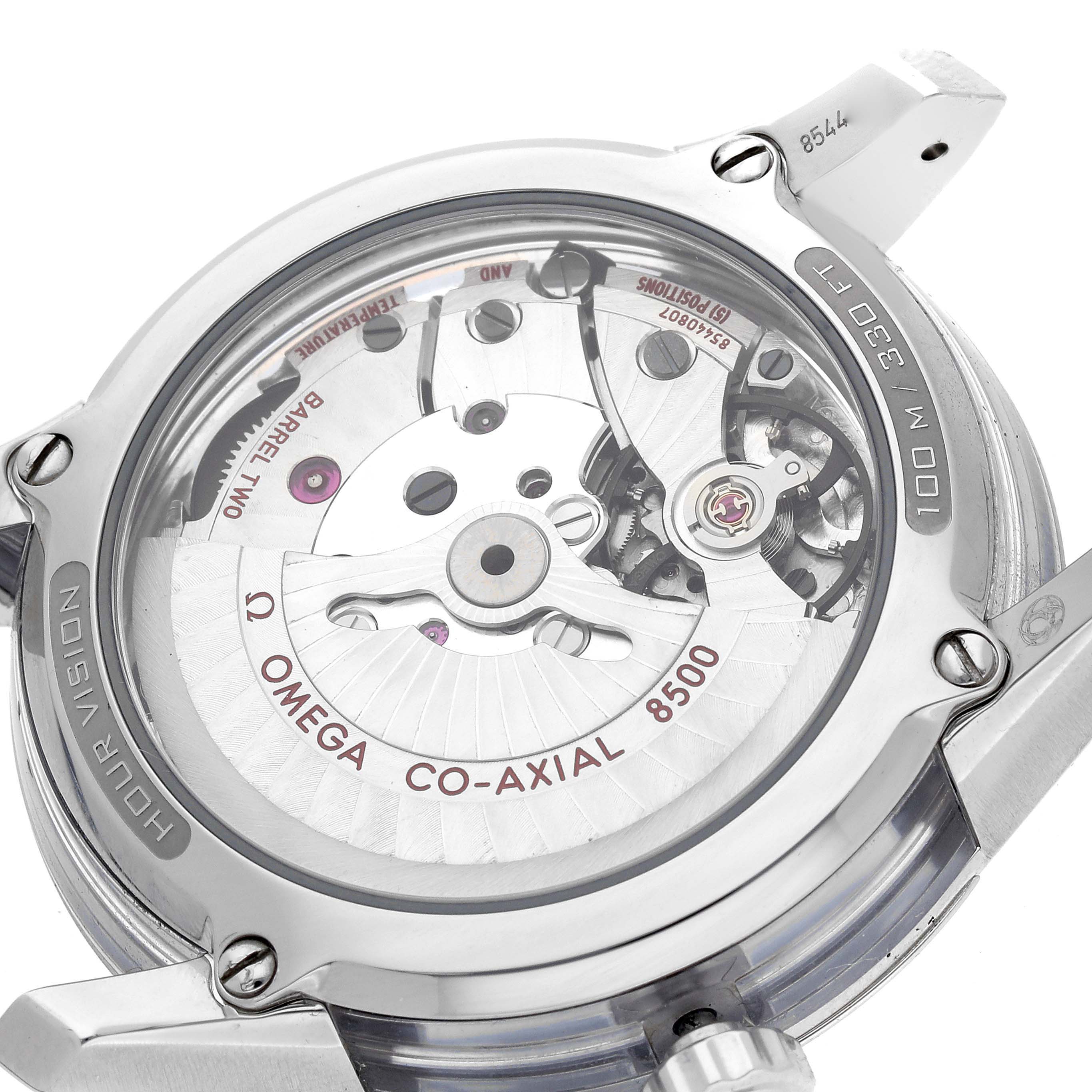 The image shows the back of the Omega De Ville 431.33.41.21.02.001 Men
s Stainless Steel Silver Dial watch, revealing its Co-Axial 8500 movement with visible gears and engravings.