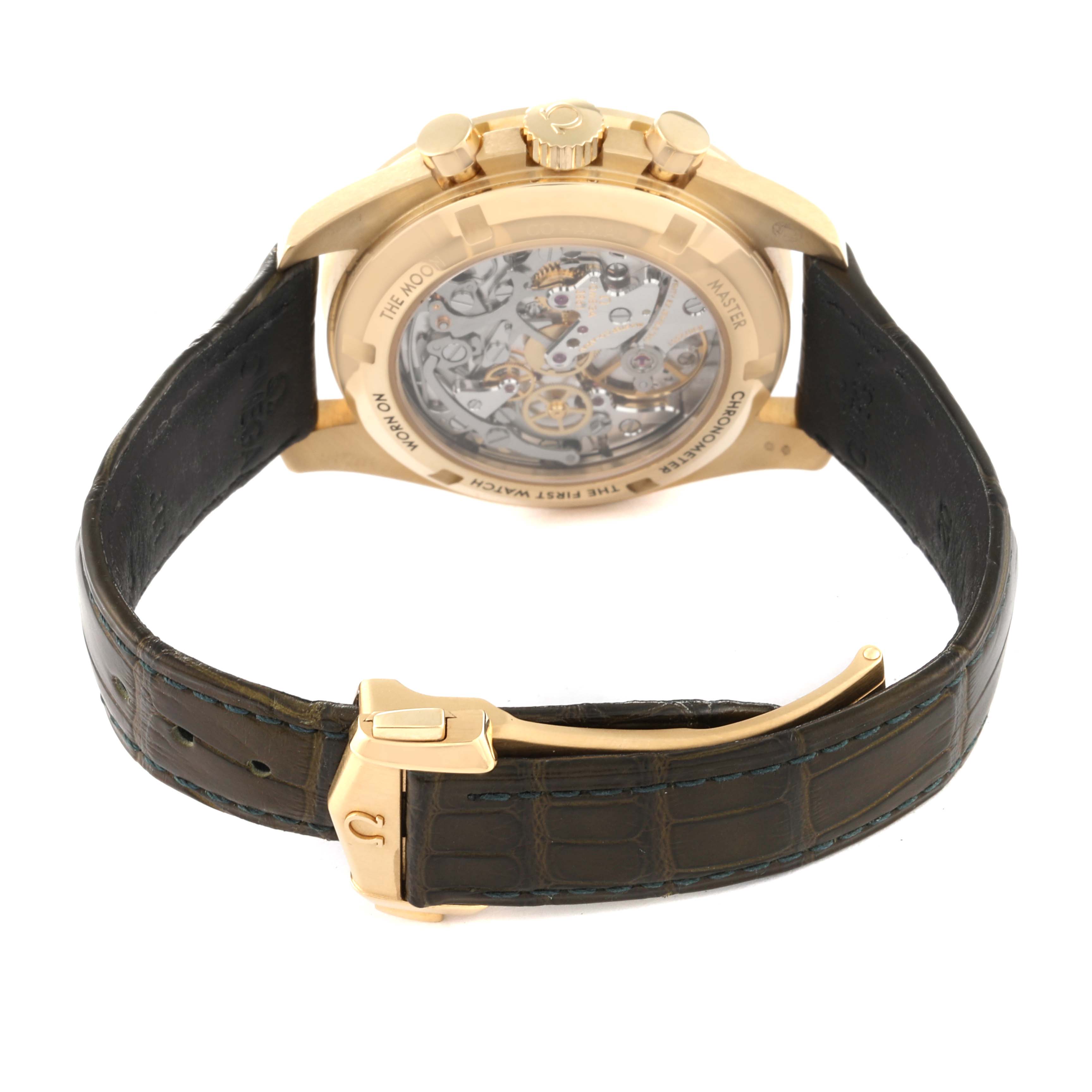 The image shows the back view of an Omega Speedmaster 310.63.42.50.10.001 Men's Yellow Gold Green Dial 310.63.42.50.10.001 Men's Yellow Gold Green Dial watch, highlighting its transparent case back and leather strap.