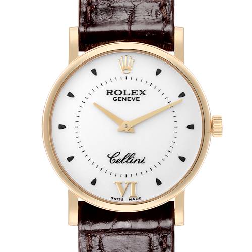 The Rolex Cellini watch is shown from a straight-on angle, displaying the face, case, crown, and part of the leather strap.