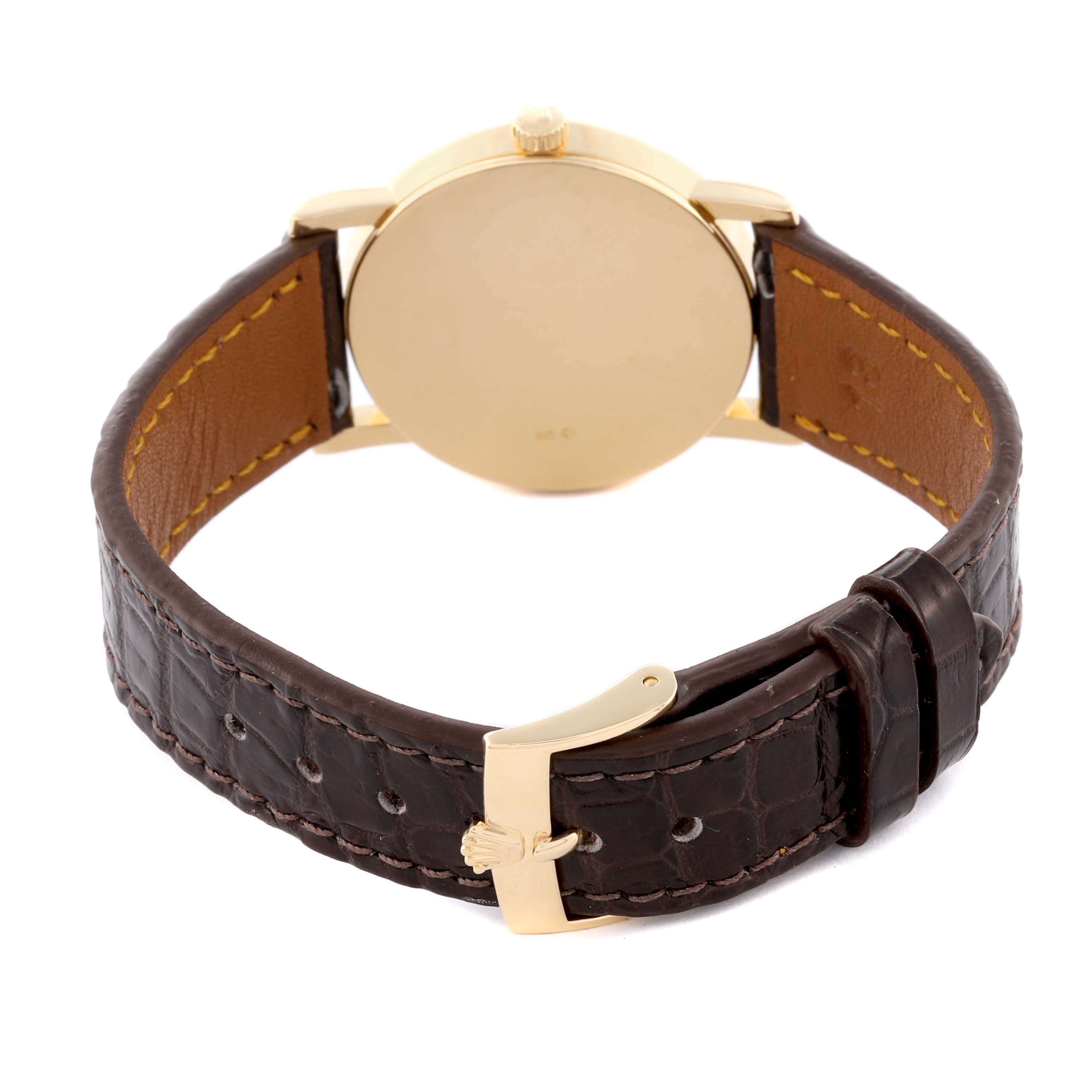 The Rolex Cellini 5115 Men's Yellow Gold Silver Dial 5115 Men's Yellow Gold Silver Dial watch is shown from the back, highlighting the leather strap and clasp.