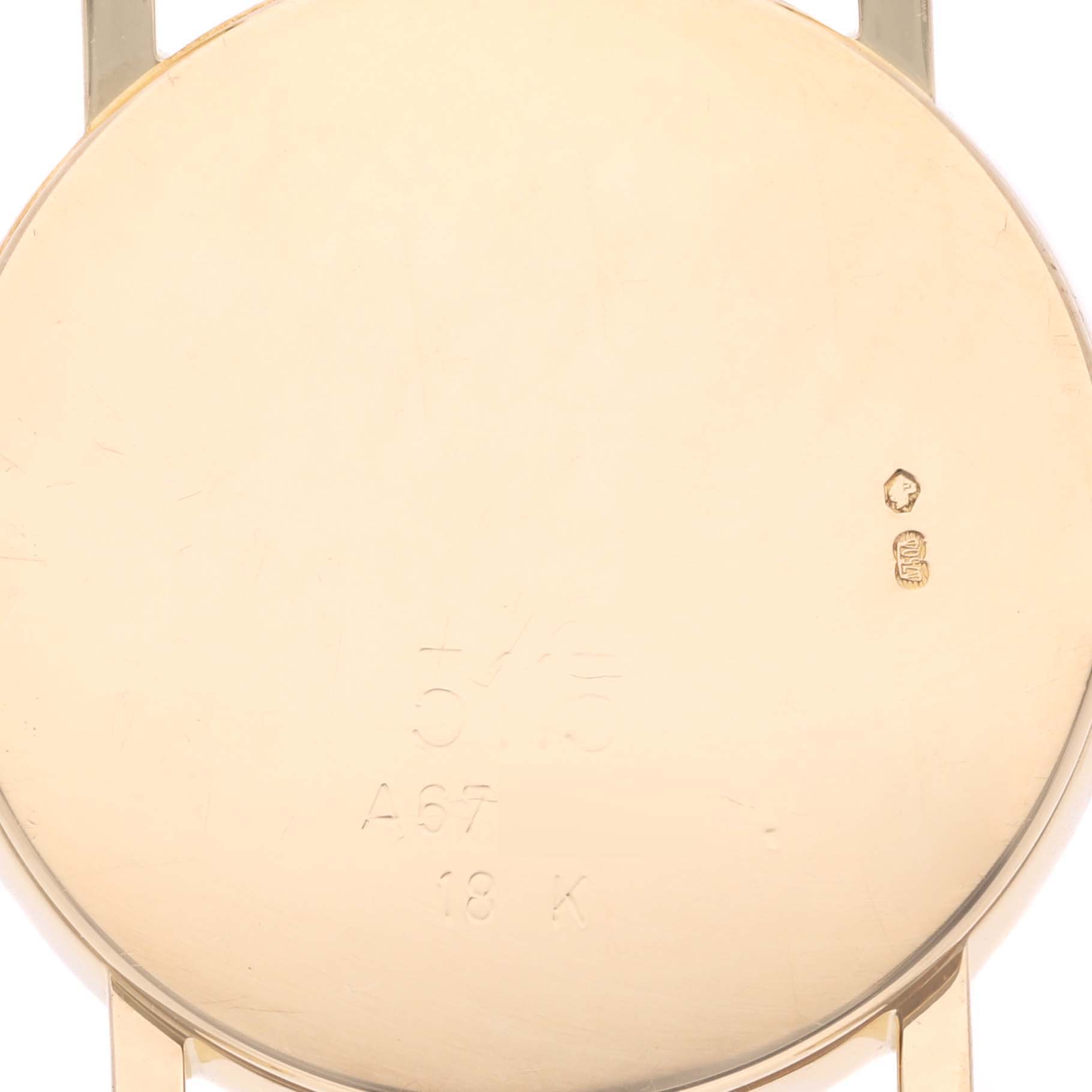 The image shows the back of a Rolex Cellini 5115 Men's Yellow Gold Silver Dial 5115 Men's Yellow Gold Silver Dial watch case, highlighting engravings and metal marks.