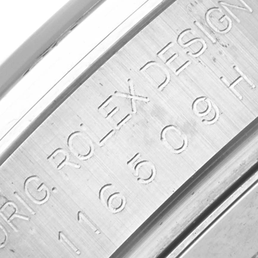 The image shows a close-up of the engraved inner bezel of the Rolex Daytona 116509 Men's White Gold Black Dial 116509 Men's White Gold Black Dial watch.