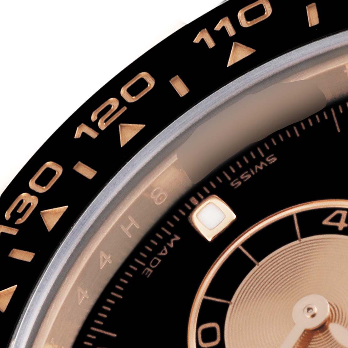 This close-up shows part of the bezel and dial of a Rolex Daytona 116515LN Men's Rose Gold Black Dial 116515LN Men's Rose Gold Black Dial watch.