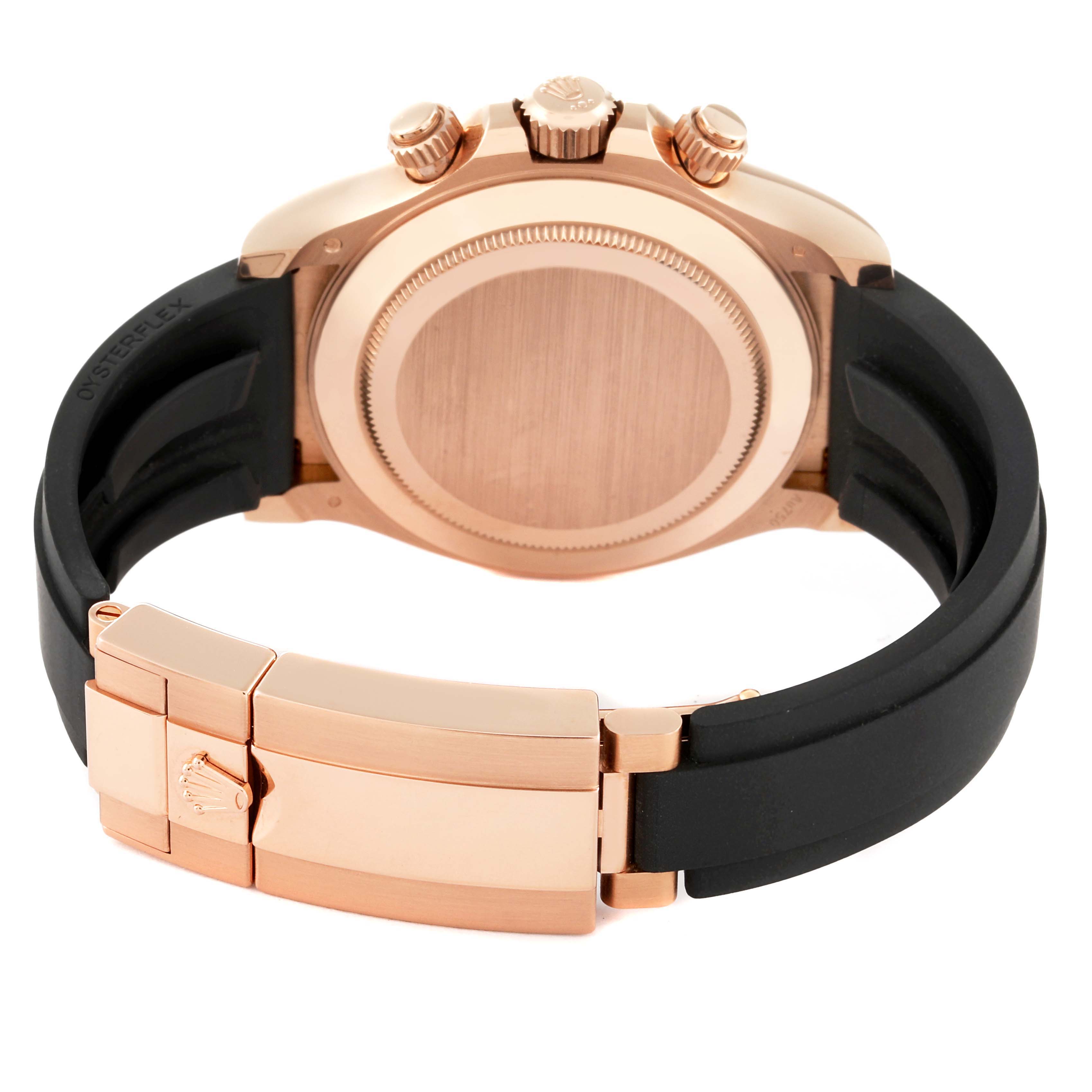 This image shows the back of a Rolex Daytona 116515LN Men's Rose Gold Black Dial 116515LN Men's Rose Gold Black Dial watch with its gold case and black Oysterflex strap, including the clasp.