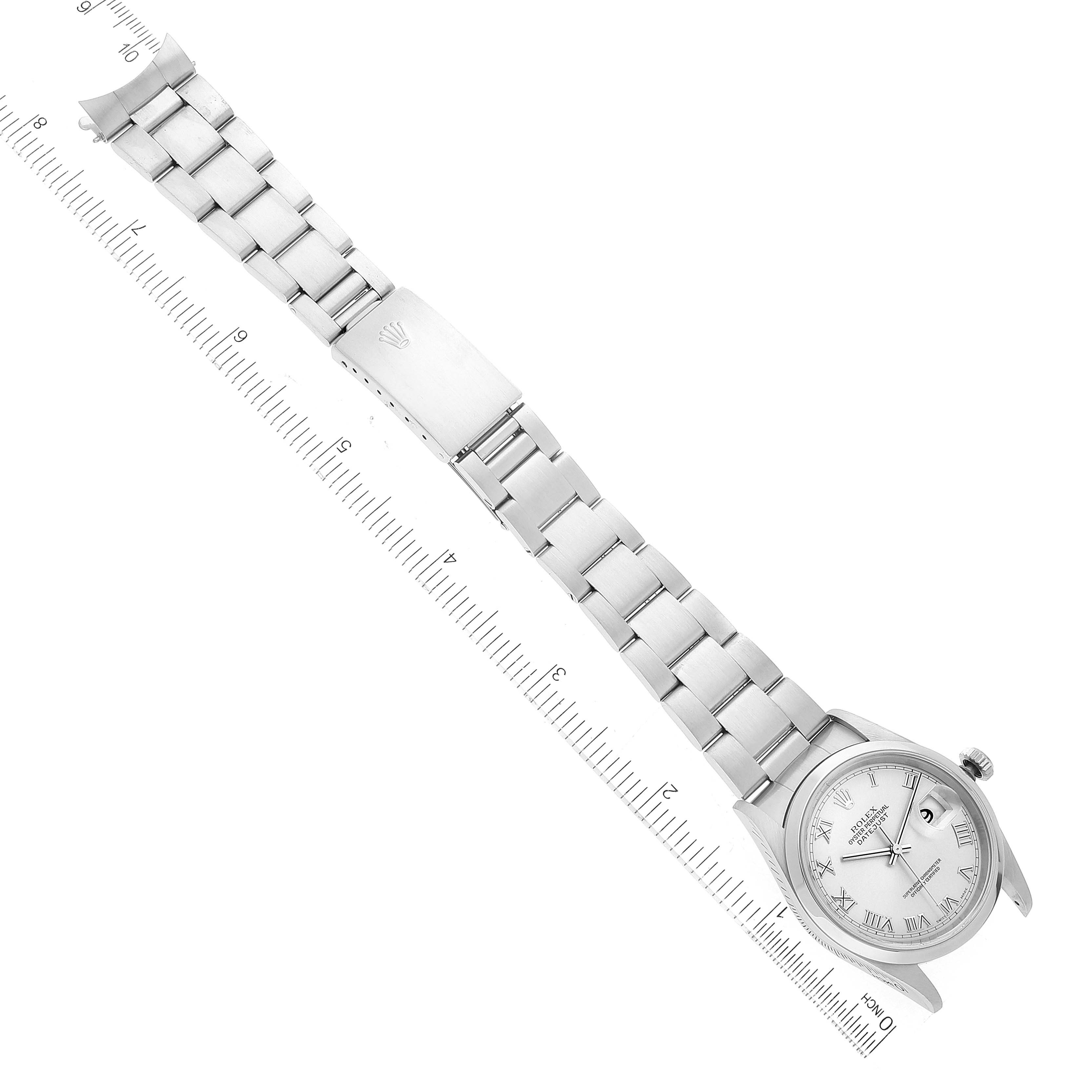 The Rolex Datejust 16200 Men's Stainless Steel Grey Dial 16200 Men's Stainless Steel Grey Dial watch is displayed horizontally, showing its full bracelet, clasp, and face, alongside a ruler for scale.