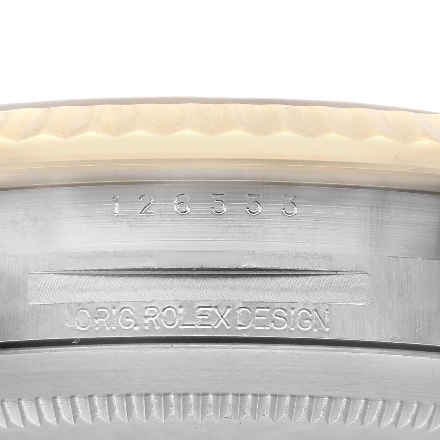 The image shows a close-up of the outer edge and engravings on the bezel of a Rolex Datejust 41 126333 Men's Steel and Gold (two tone) White Dial 126333 Men's Steel and Gold (two tone) White Dial.