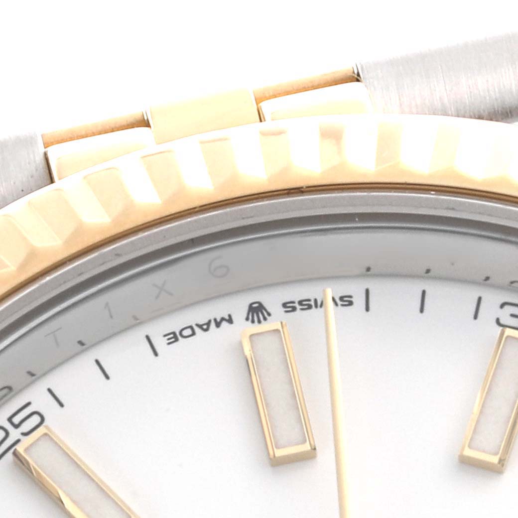The image shows a close-up of the Rolex Datejust 41 126333 Men's Steel and Gold (two tone) White Dial 126333 Men's Steel and Gold (two tone) White Dial's dial, bezel, and part of the bracelet at an angled view.
