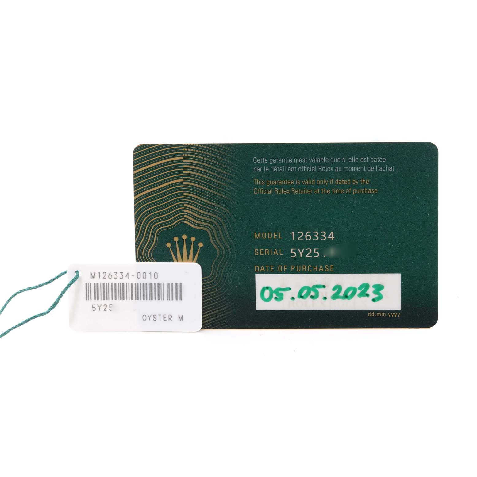 This image shows the warranty card for the Rolex Datejust 41 126334 Men's Stainless Steel White Dial 126334 Men's Stainless Steel White Dial model 126334, along with a tag displaying the serial number.